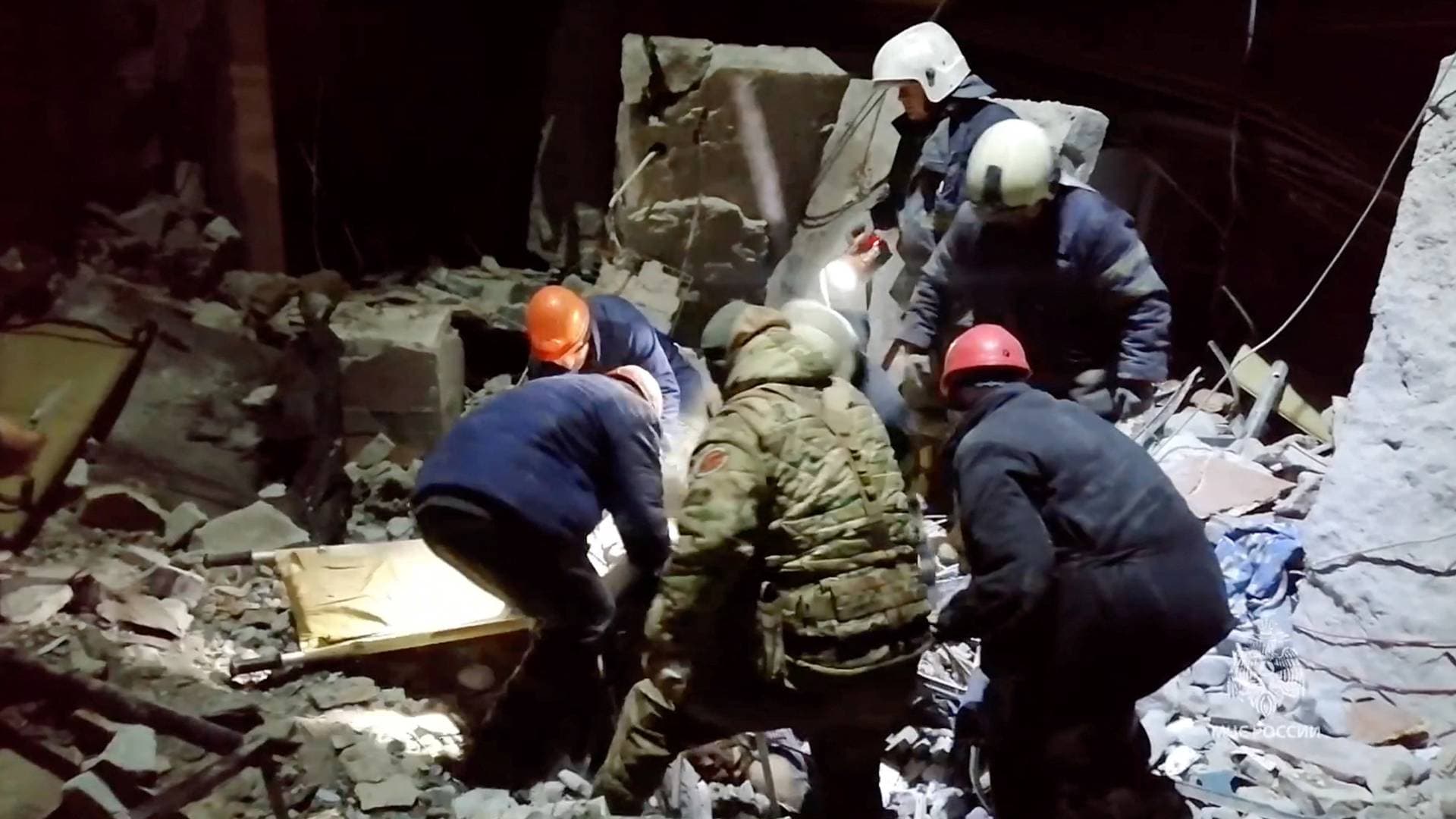 Emergency workers retrieve bodies from the rubble of a building following a missile strike in Lysychansk on February 3.