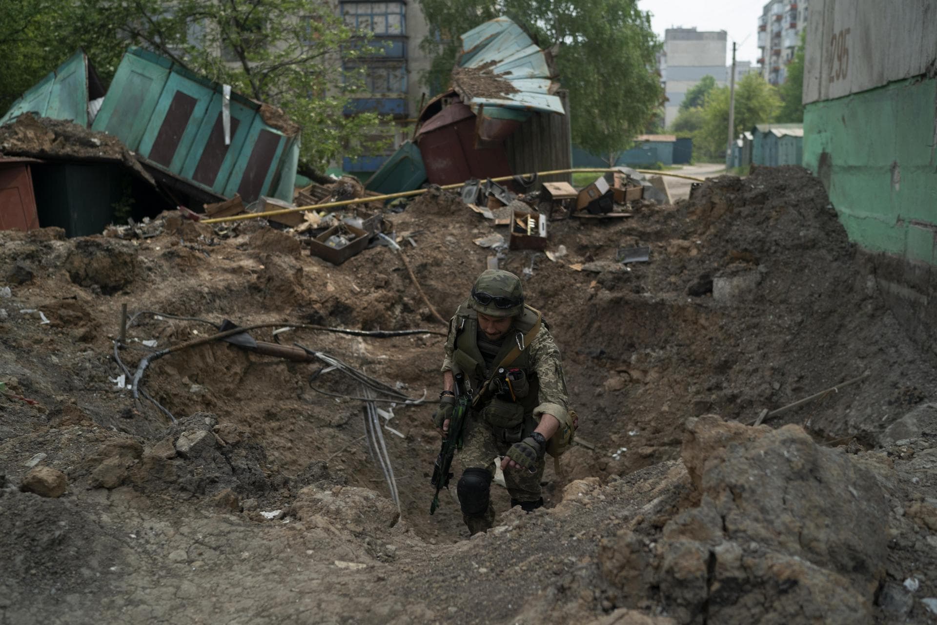 A special task force policeman inspects a site after an airstrike by Russian forces in Lysychansk