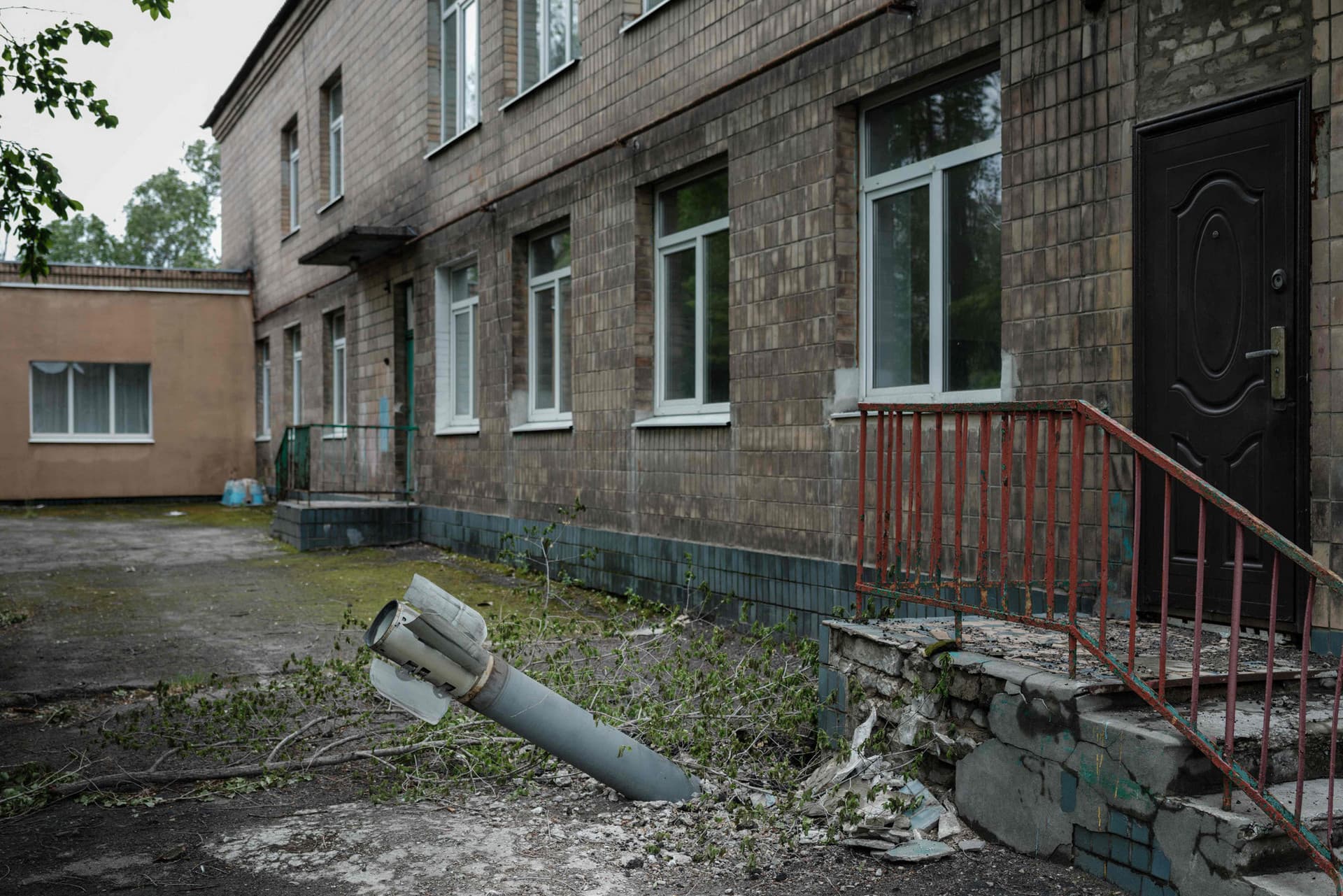 An unexploded ordnance is stuck outside a kindergarten where seven people have been sheltering in the basement for more than two months, in Lysychansk
