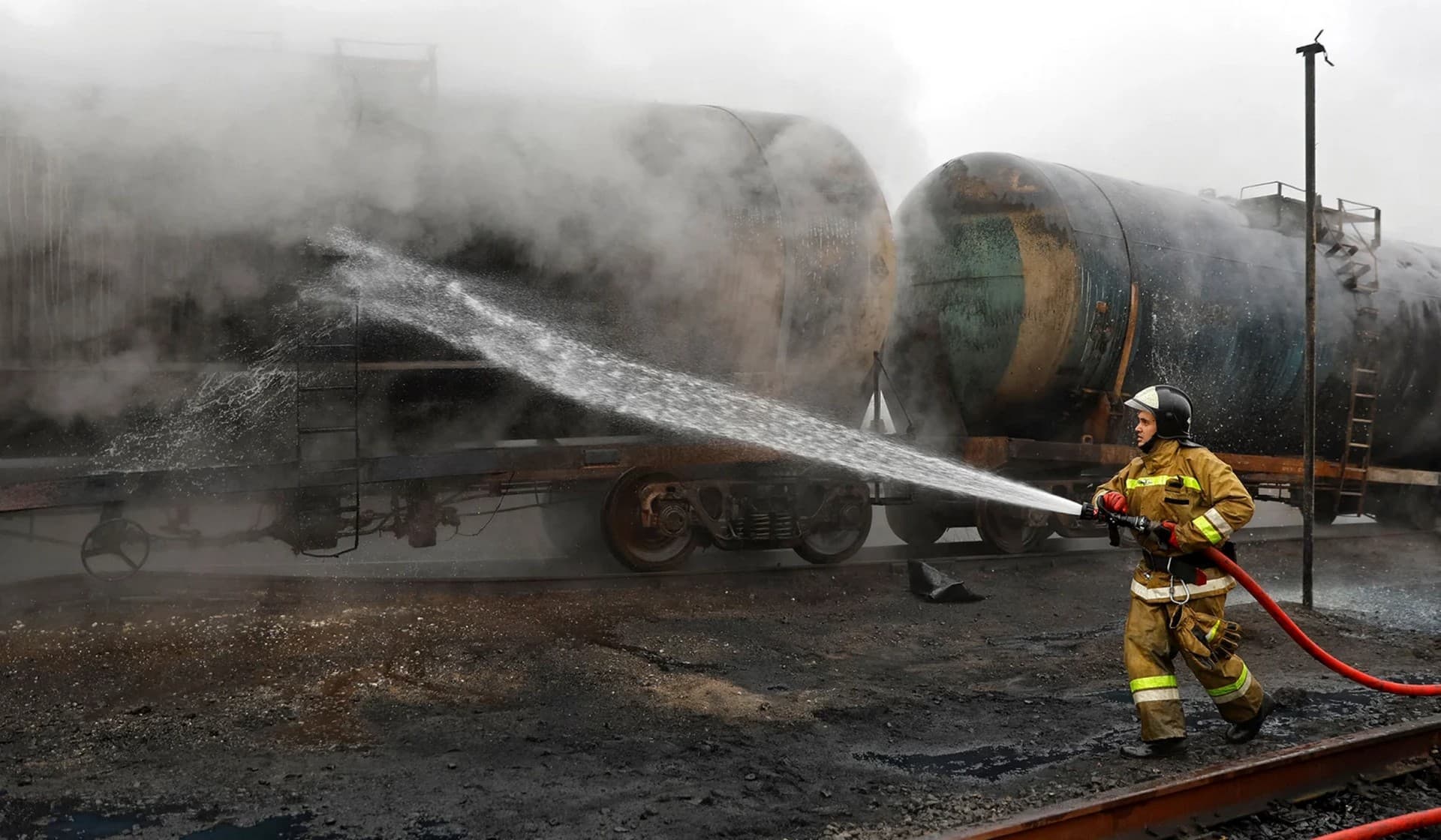 A firefighter works to extinguish fire at a fuel storage site after shelling in Makiivka