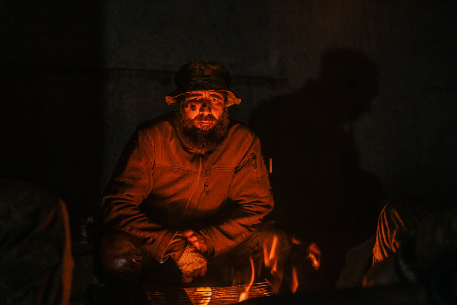 A Ukrainian soldier inside the ruined Azovstal steel plant takes a rest in his shelter in Mariupol