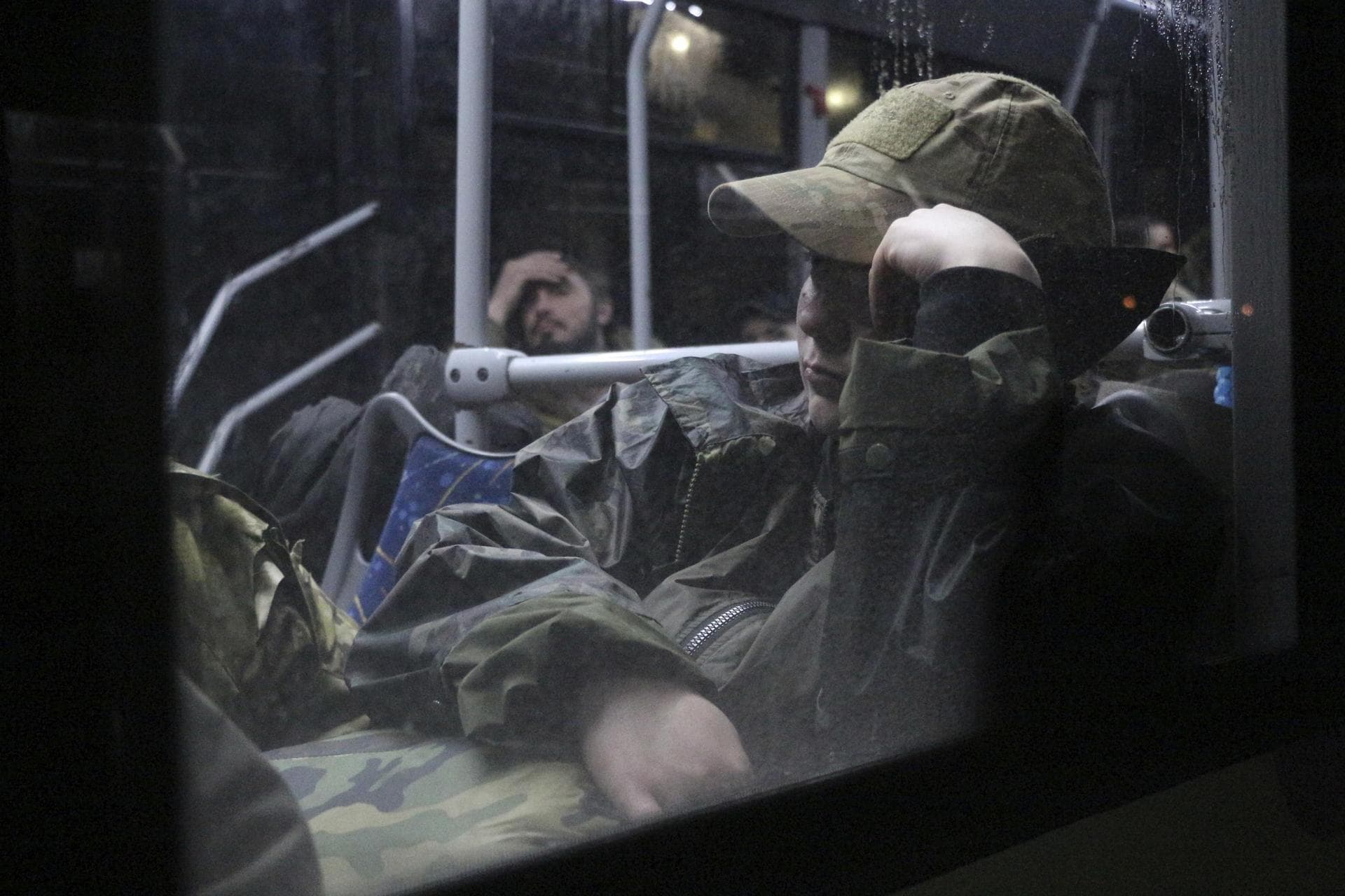 Ukrainian servicemen sit in a bus after leaving Mariupol's besieged Azovstal steel plant
