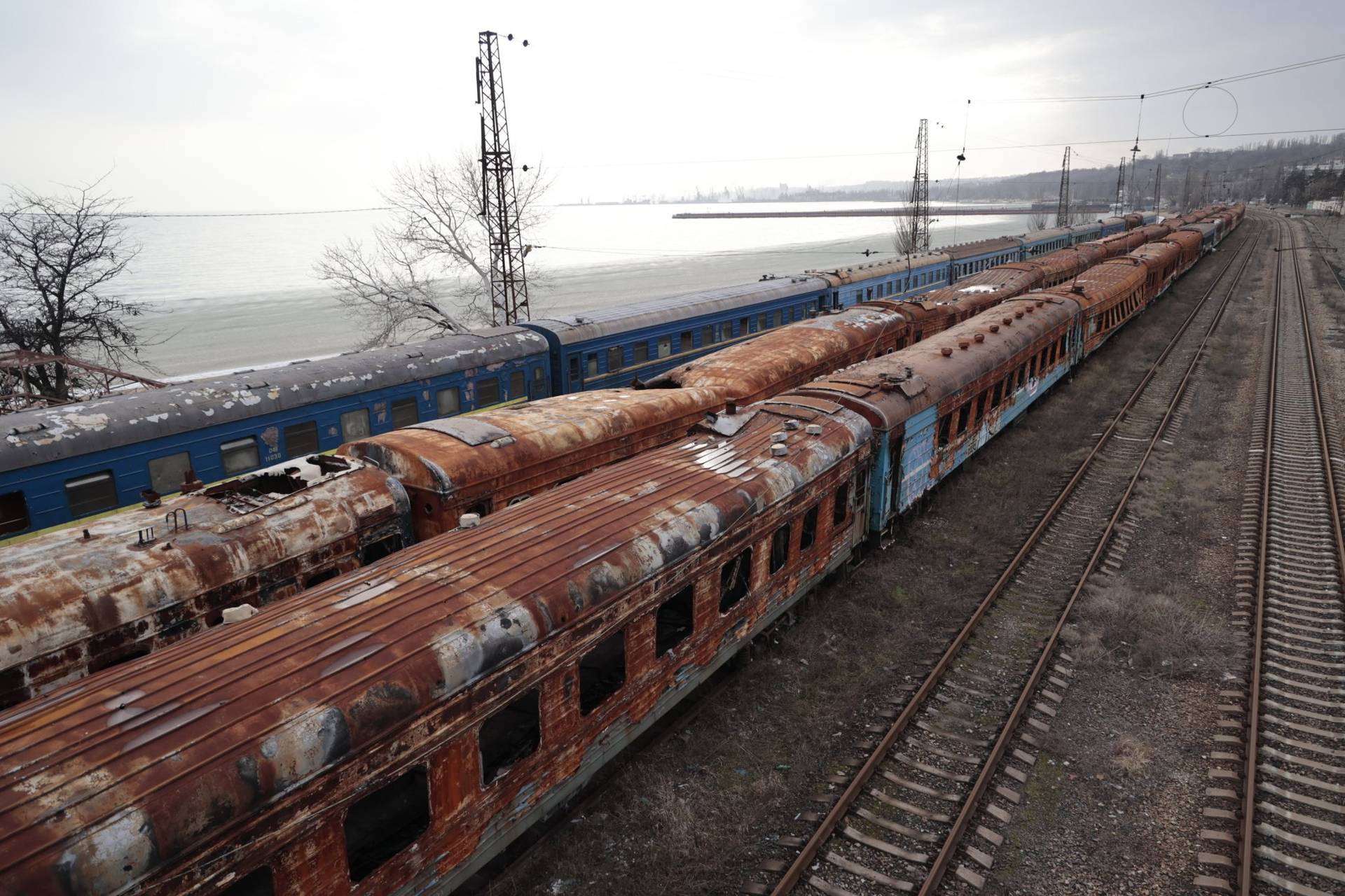 burned-out railway cars on Mariupol’s main beach, and a partly frozen Sea of Azov