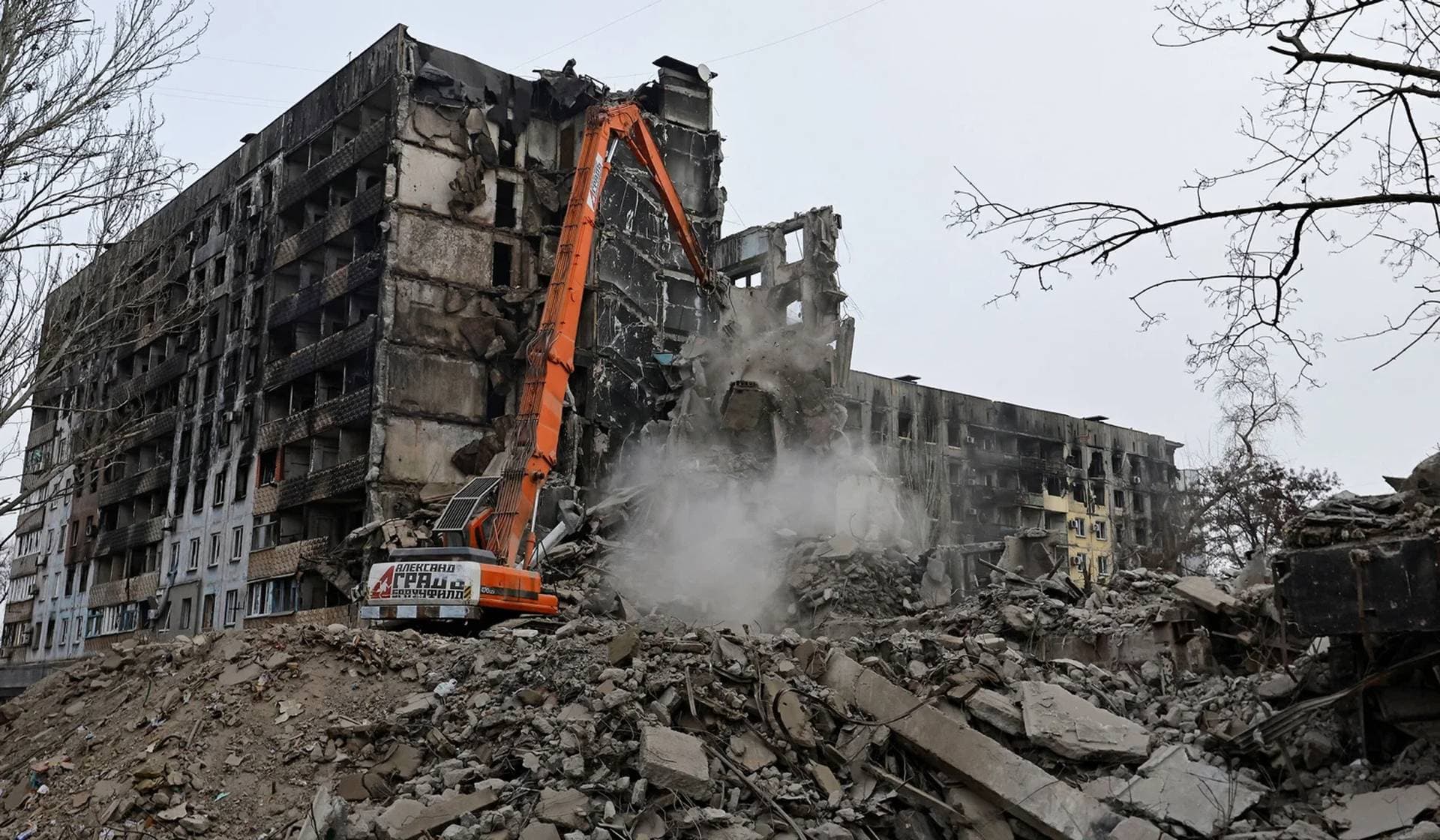 Workers demolish a multi-story apartment block which was destroyed in the course of Russia-Ukraine conflict in Mariupol
