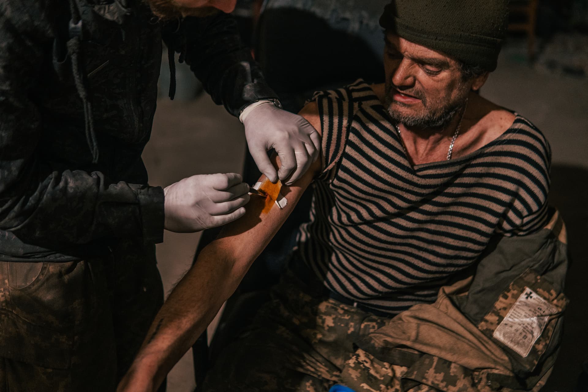 In this photo a Ukrainian soldier injured during fighting against Russian forces, gets a medical aid inside the Azovstal steel plant in Mariupol