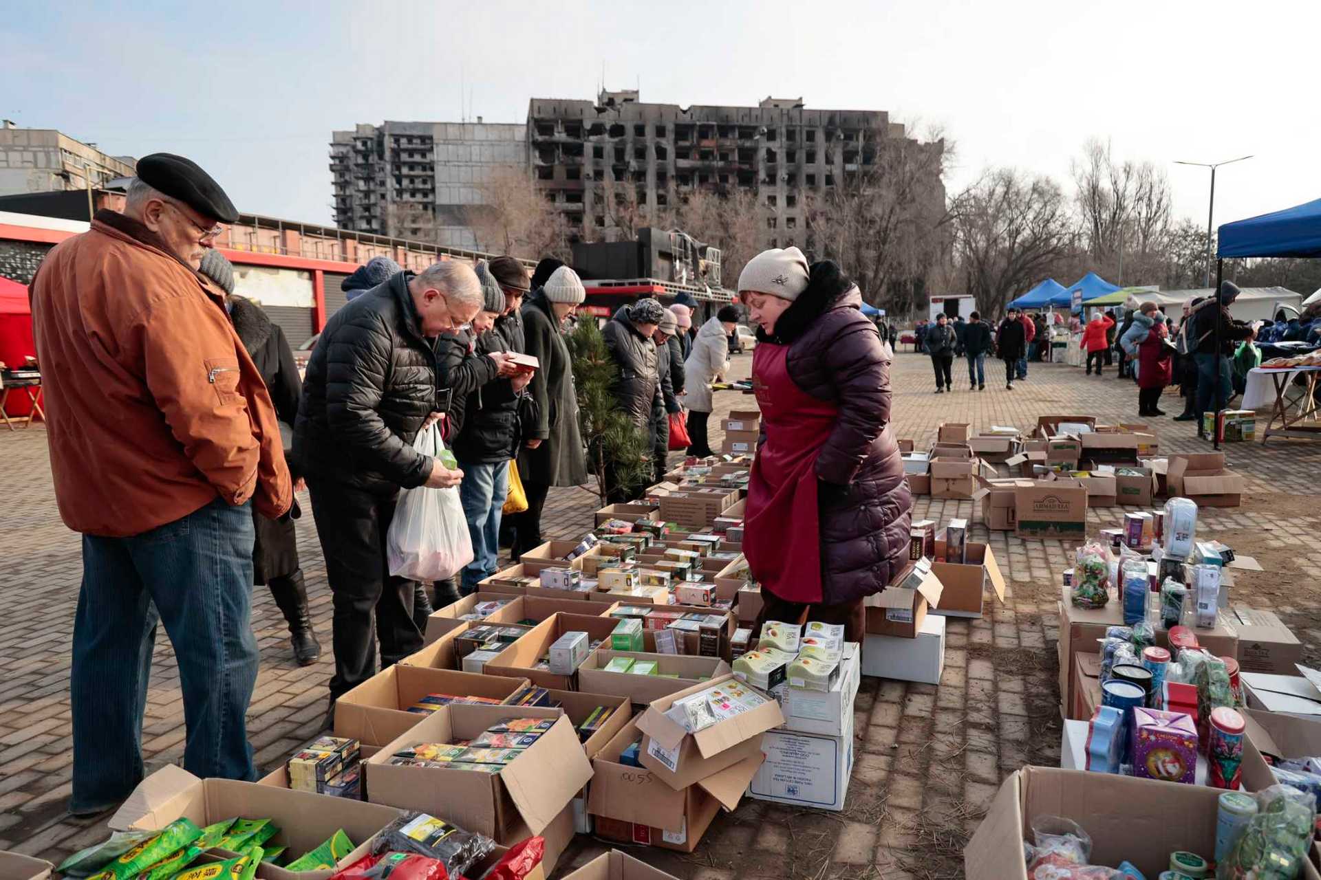 Local people buy and sell food ahead of Christmas and the New Year festivities in Mariupol