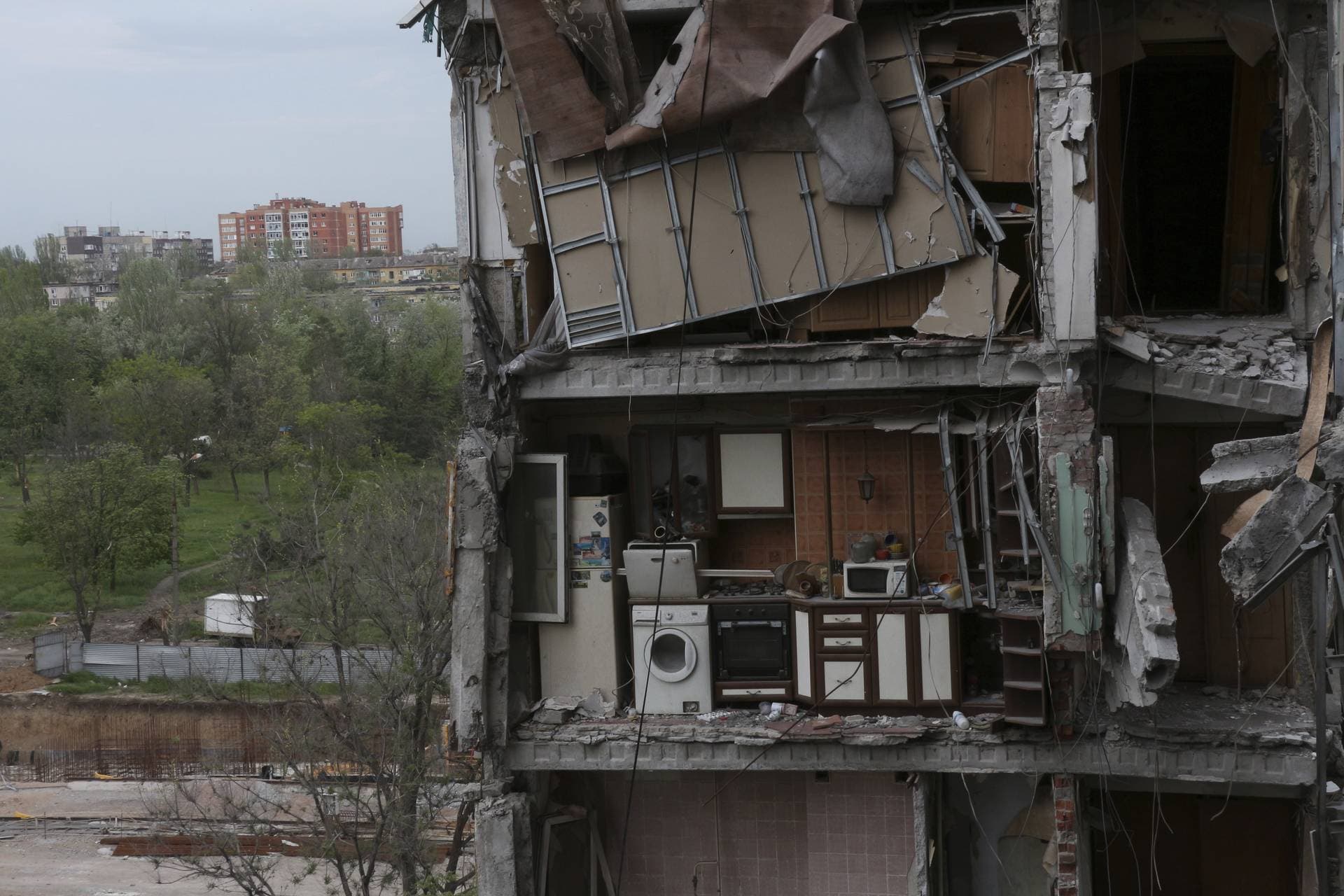 A part of an apartment is seen at the side of damaged during a heavy fighting buildings in Mariupol