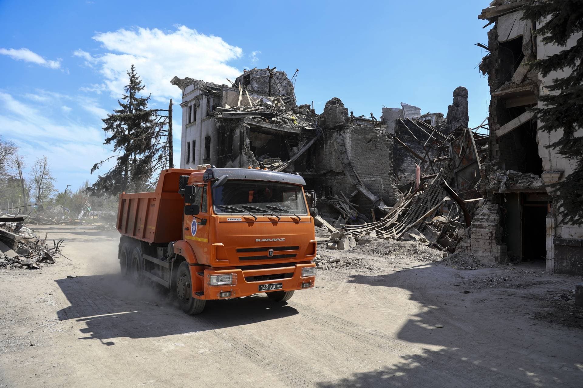 A truck drives past the Donetsk Academic Regional Drama Theatre in Mariupol