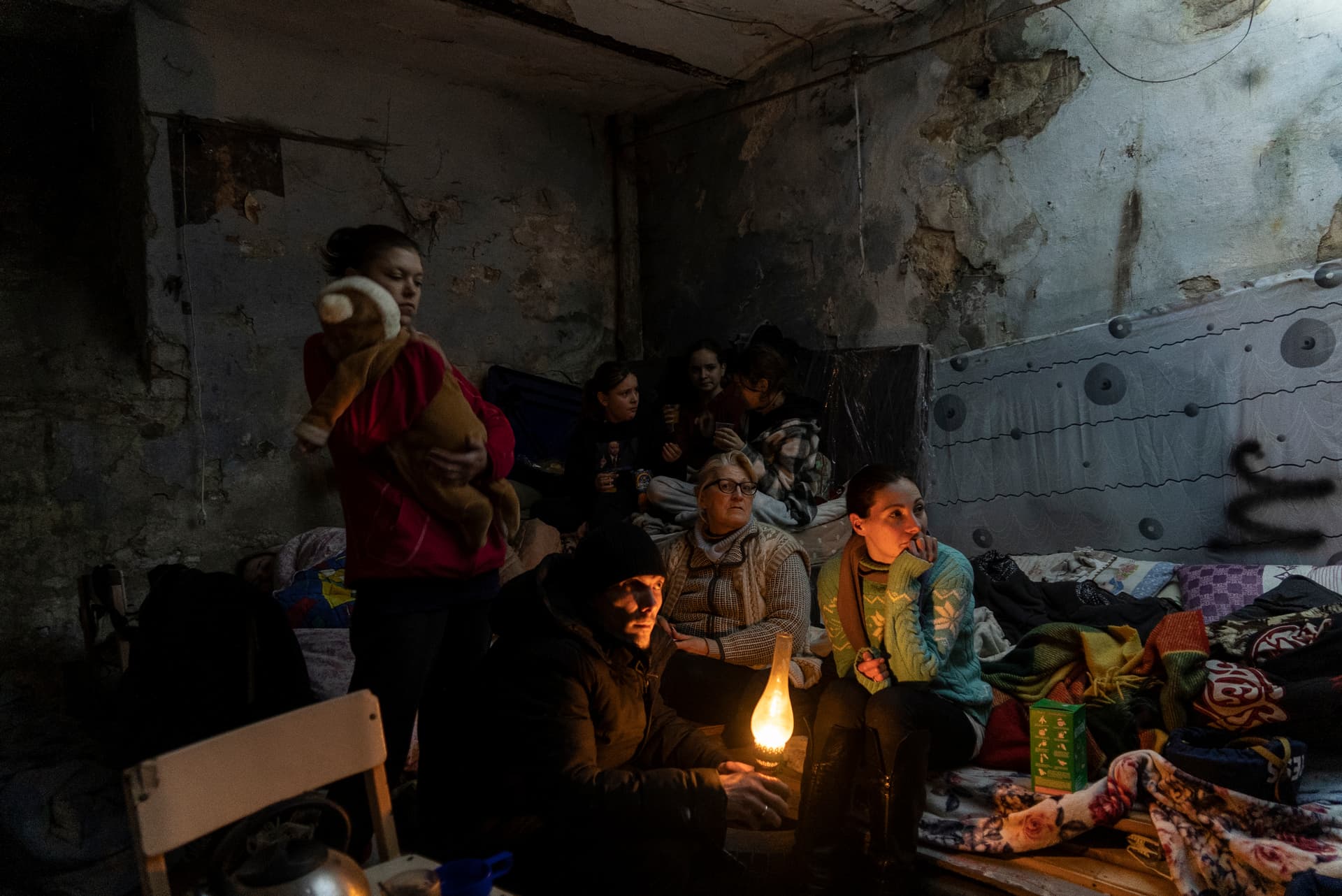 Zhanna Goma (right) and her neighbors settle in a bomb shelter in Mariupol