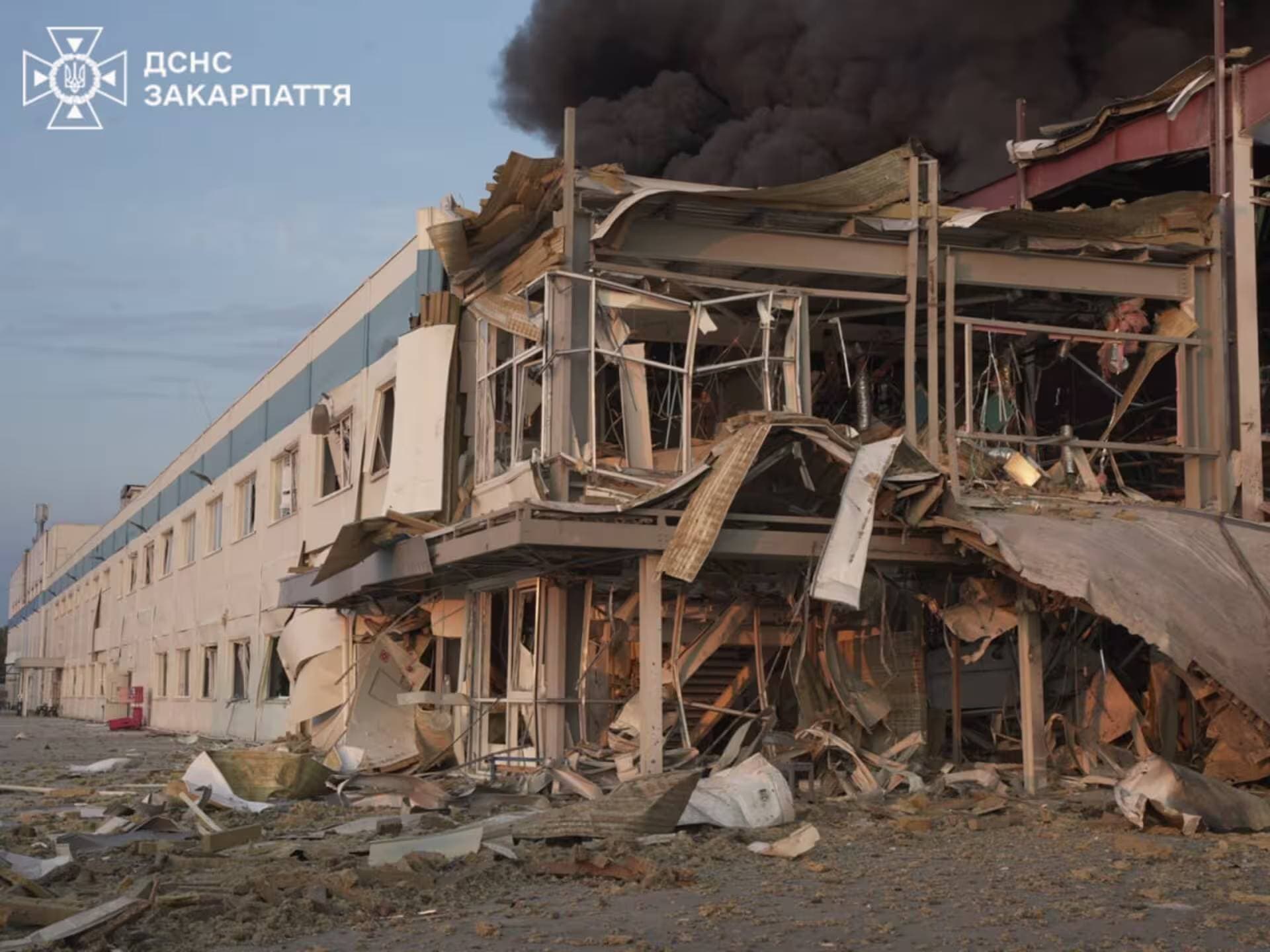 Firefighters work at the site of a Flextronics factory hit by a Russian missile strike in Mukachevo