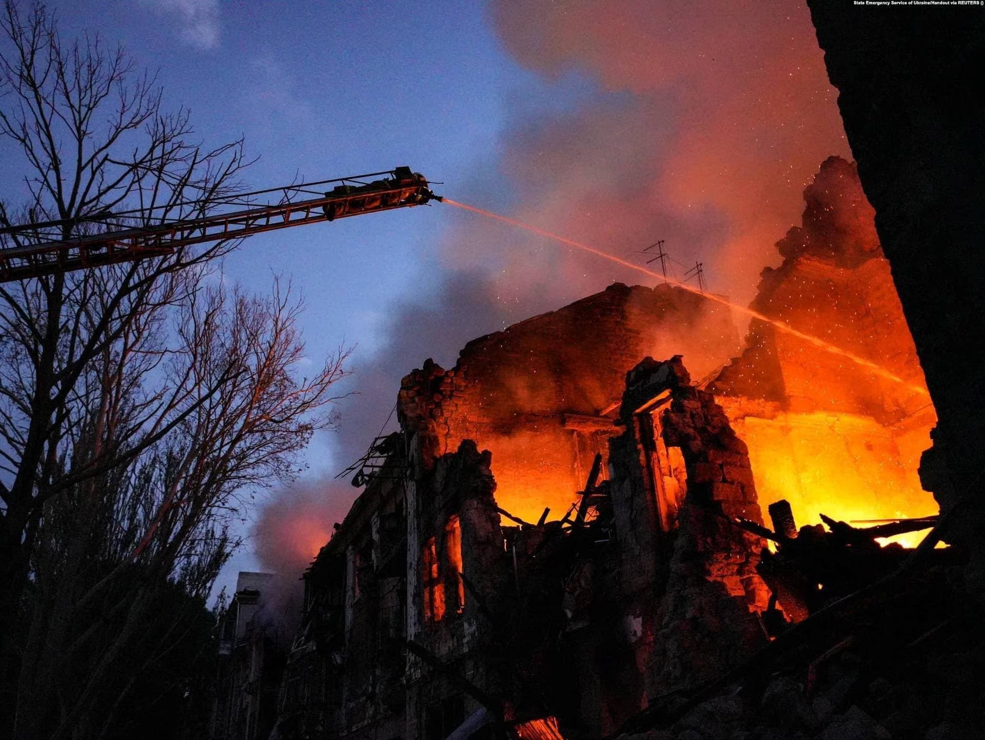 Firefighters work at the site of a three-story residential building struck by a Russian missile in Mykolayiv