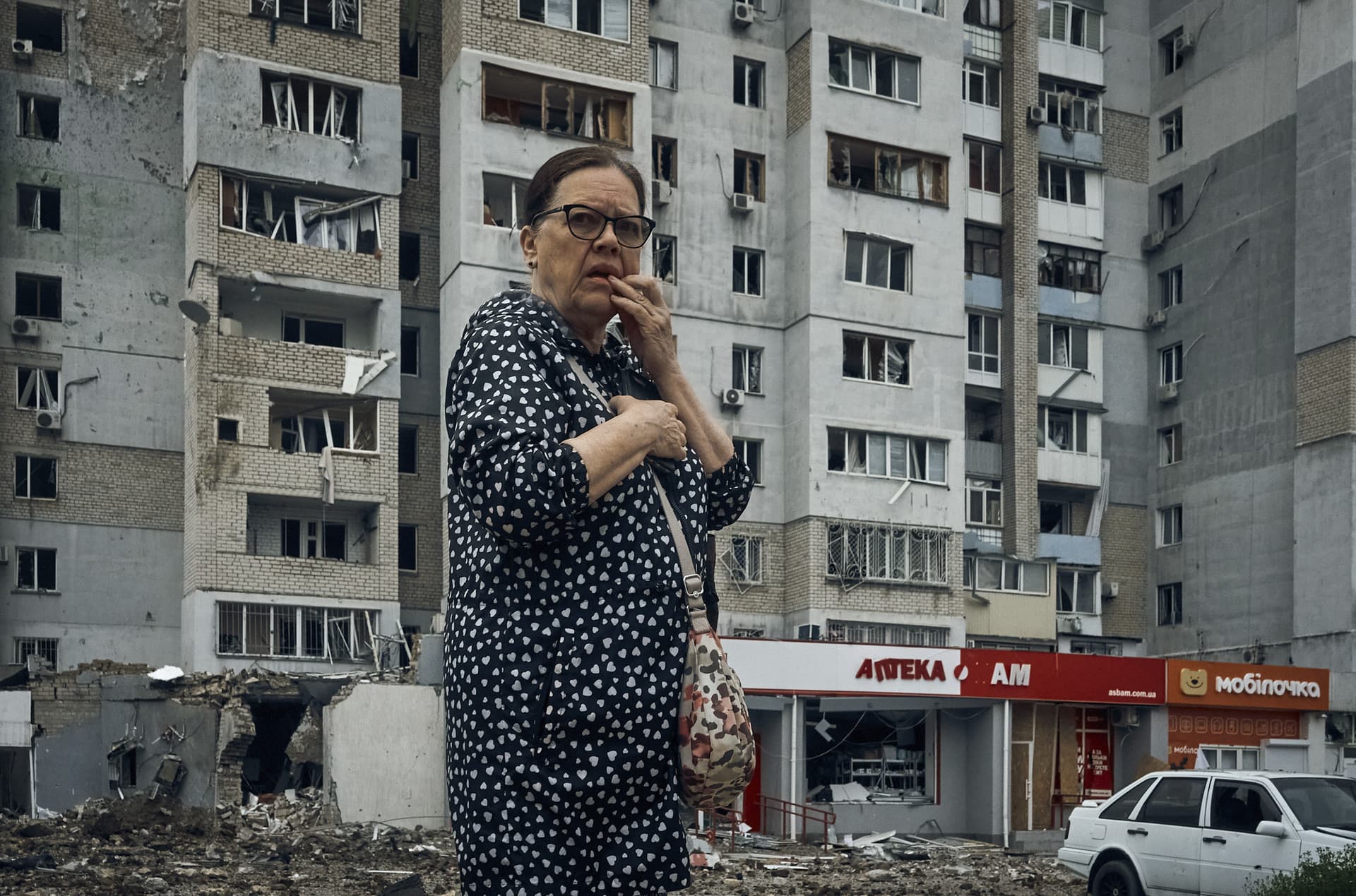 A woman stands in the aftermath of the Russian shelling in Mykolaiv