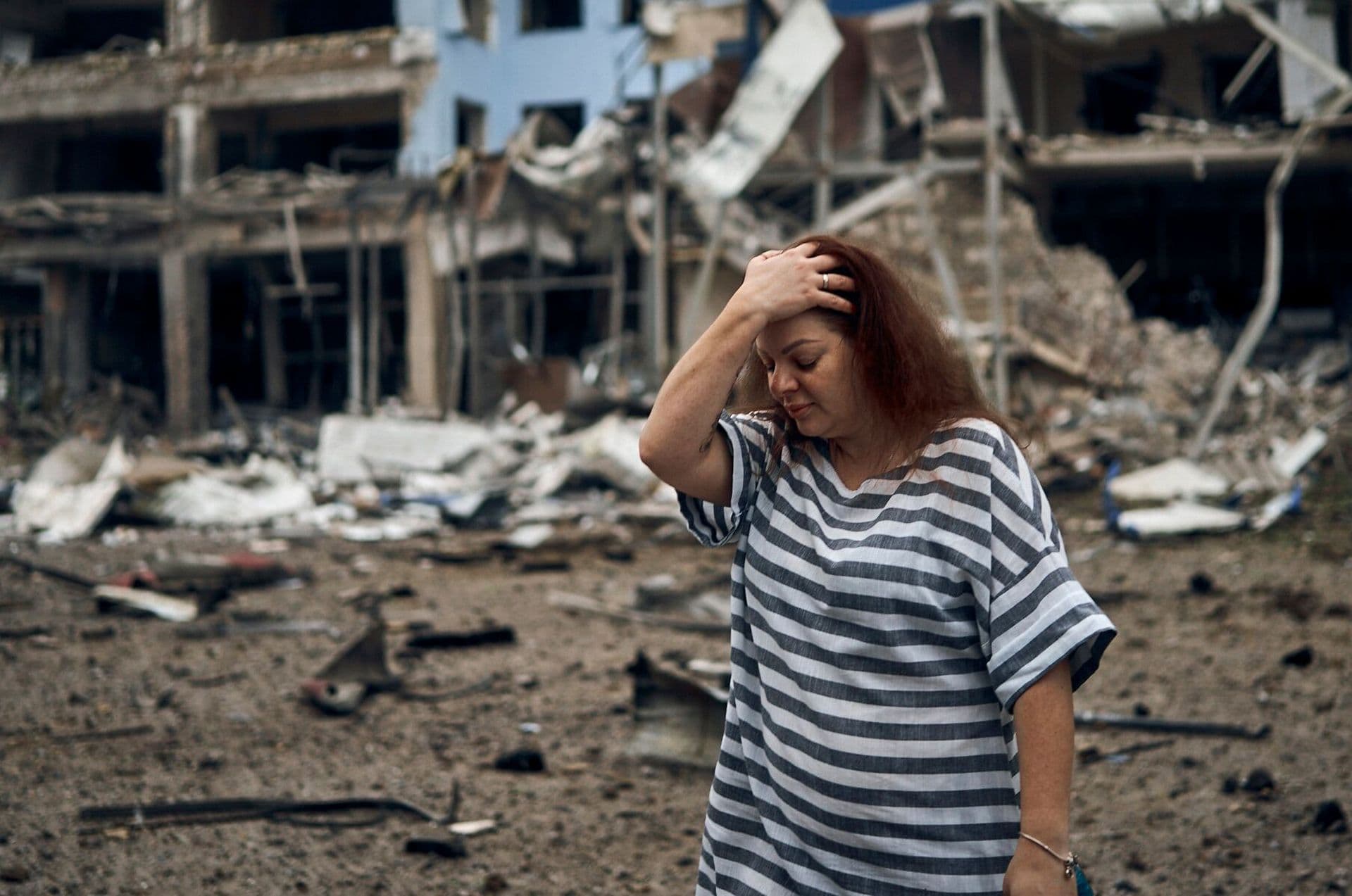 A woman stands amongst the debris after the Russian shelling in Mykolaiv