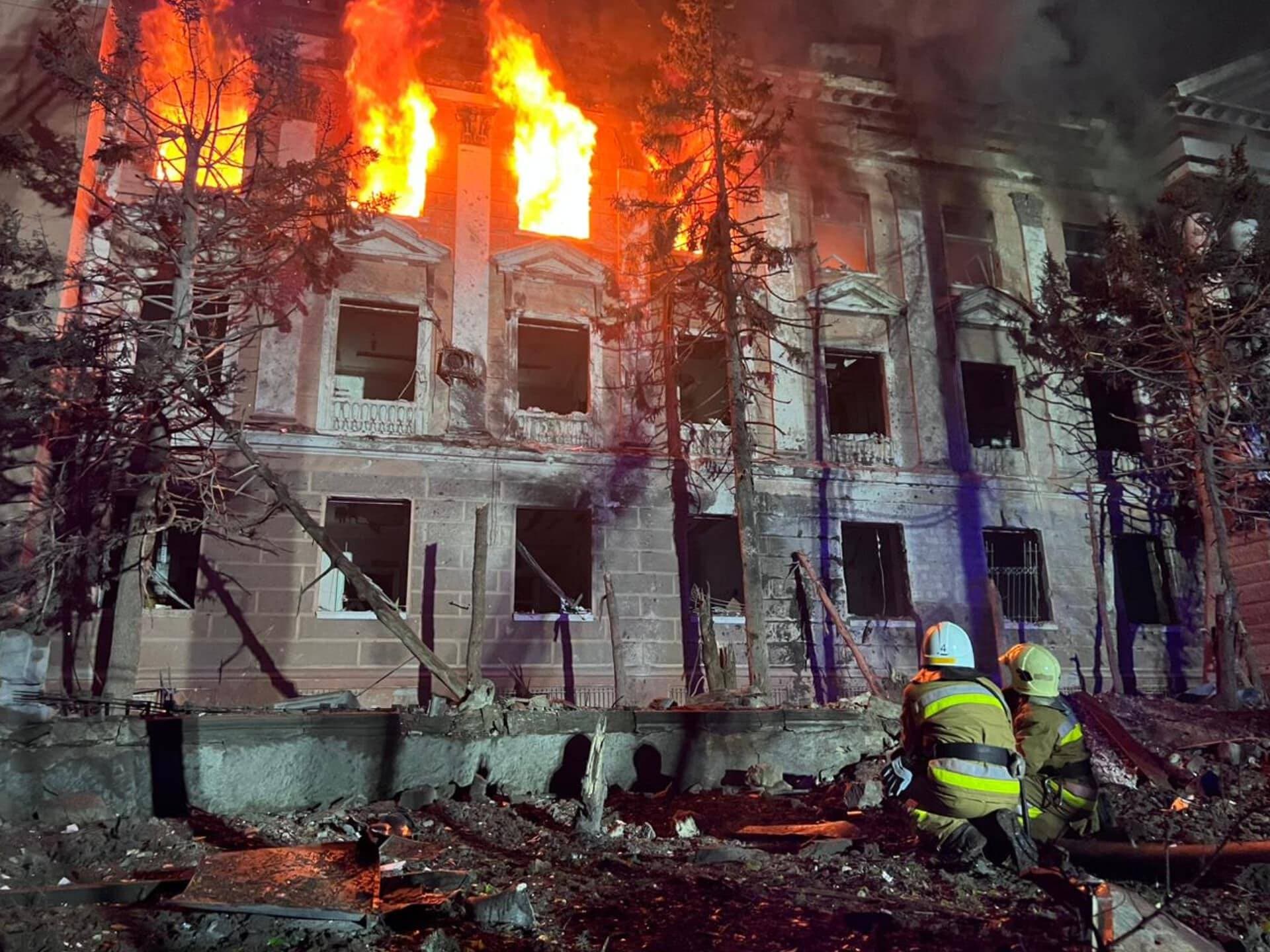 Firefighters work at a site of a building damaged by a Russian missile strike in Mykolaiv