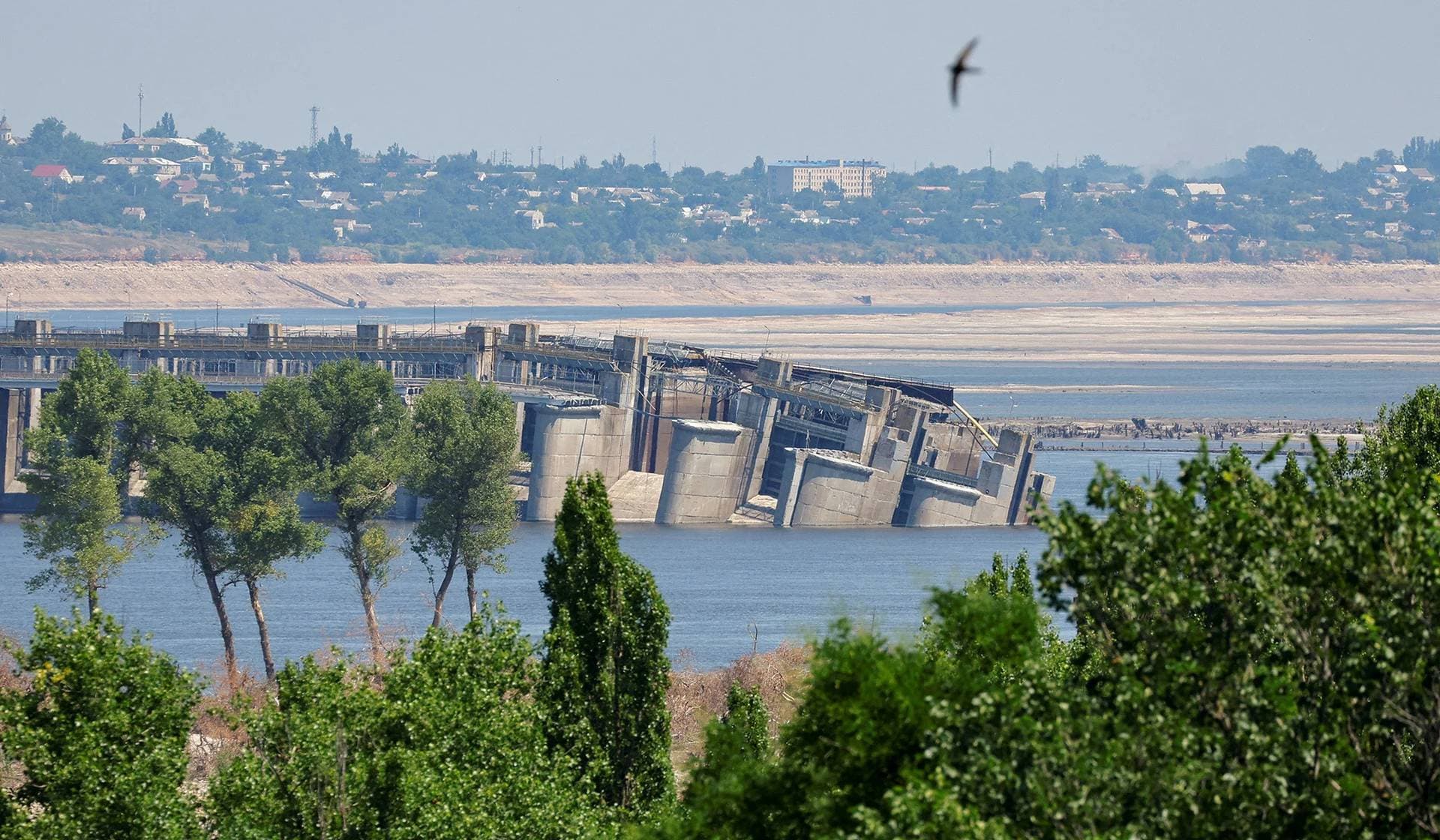 The destroyed Nova Kakhovka dam, Beryslav town and Dnipro River bank seen from the town of Nova Kakhovka