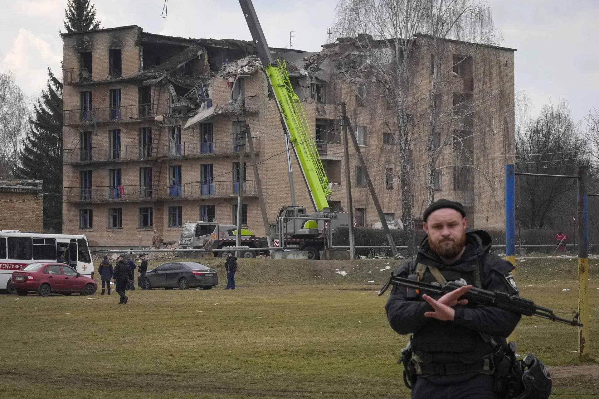 A police officer gestures to prevent photographing at the scene of a drone attack in the town of Rzhyshchiv