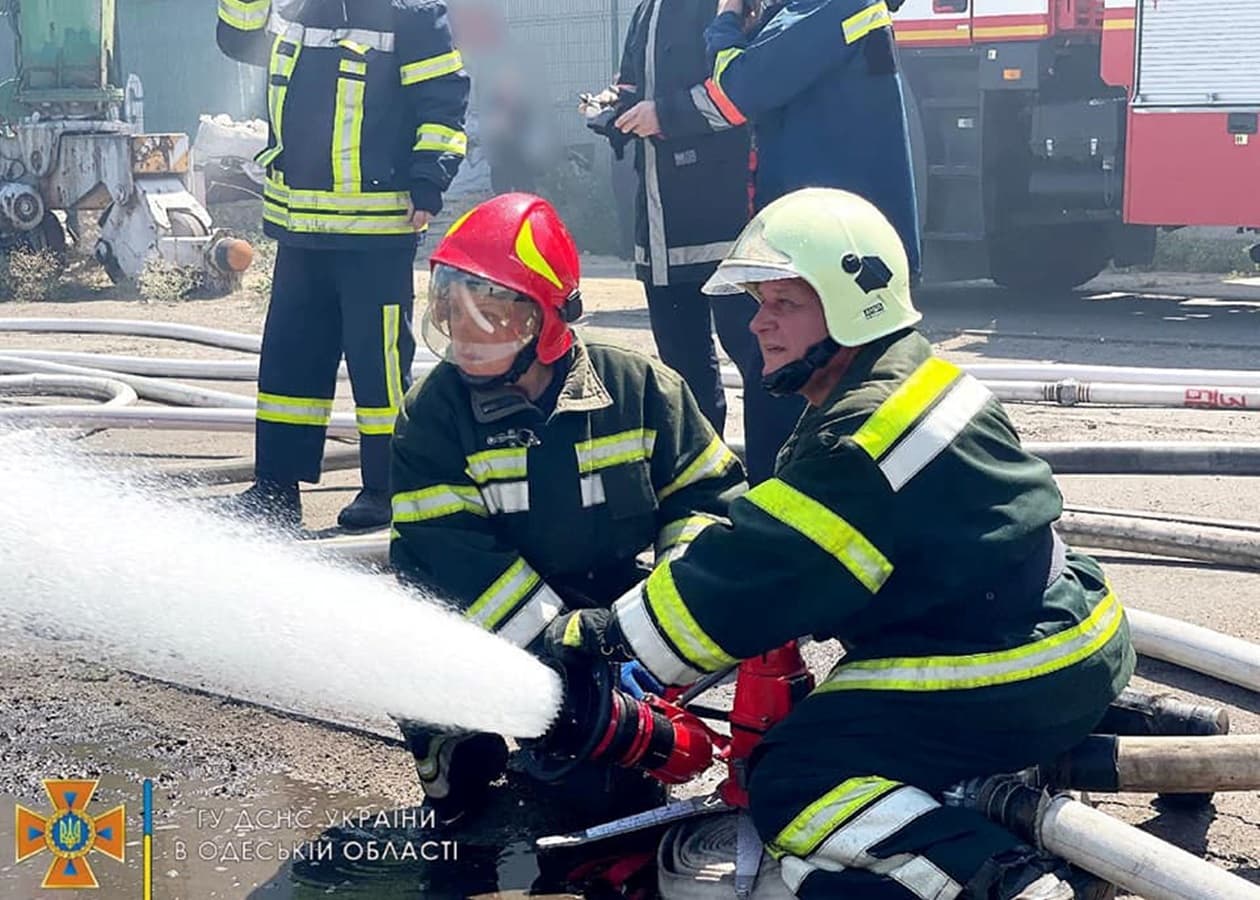 Firefighters work to put out a fire caused by a missile attack on the port in Odesa