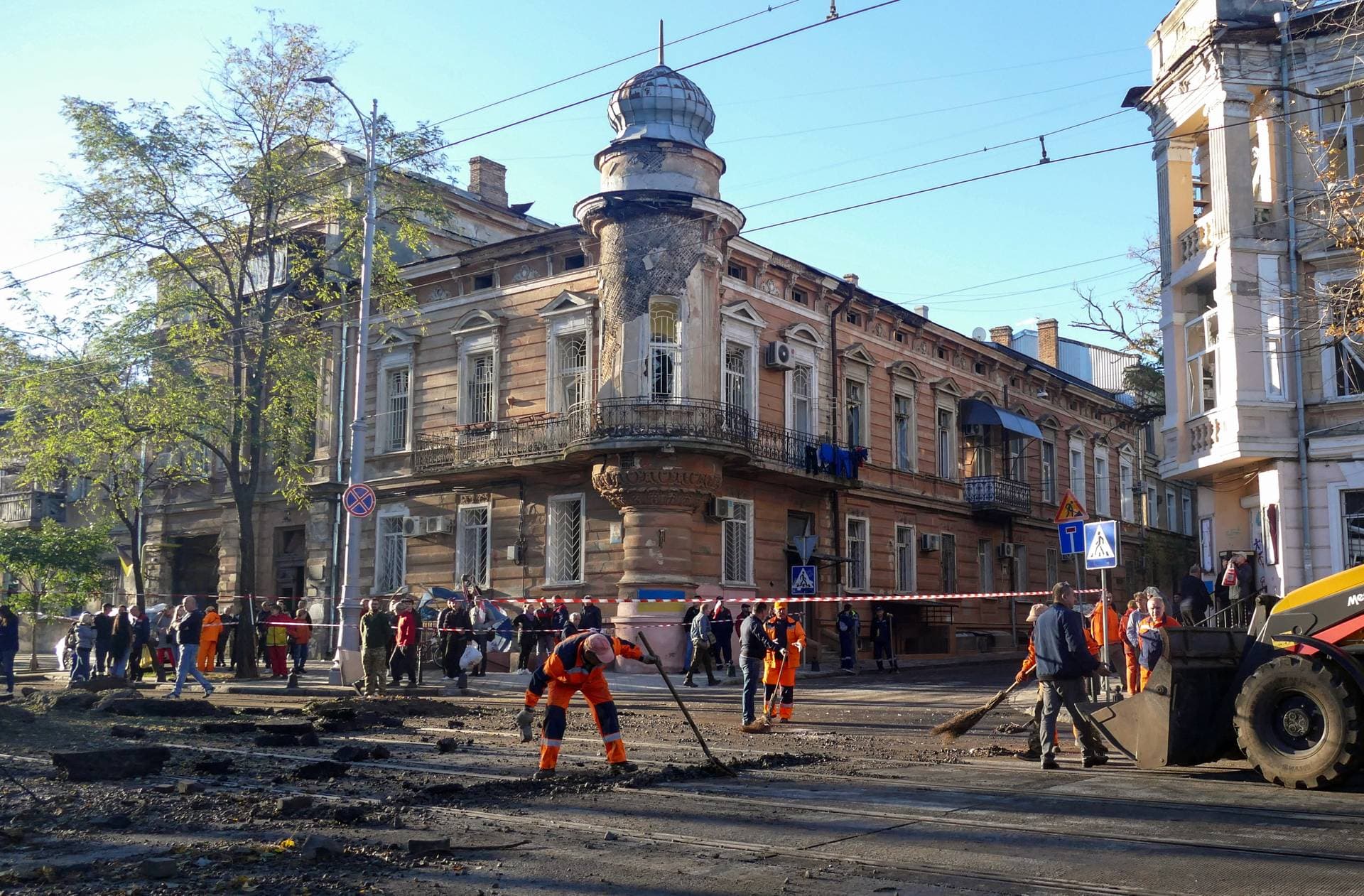 Workers clean up debris near the museum after the attack on Odesa