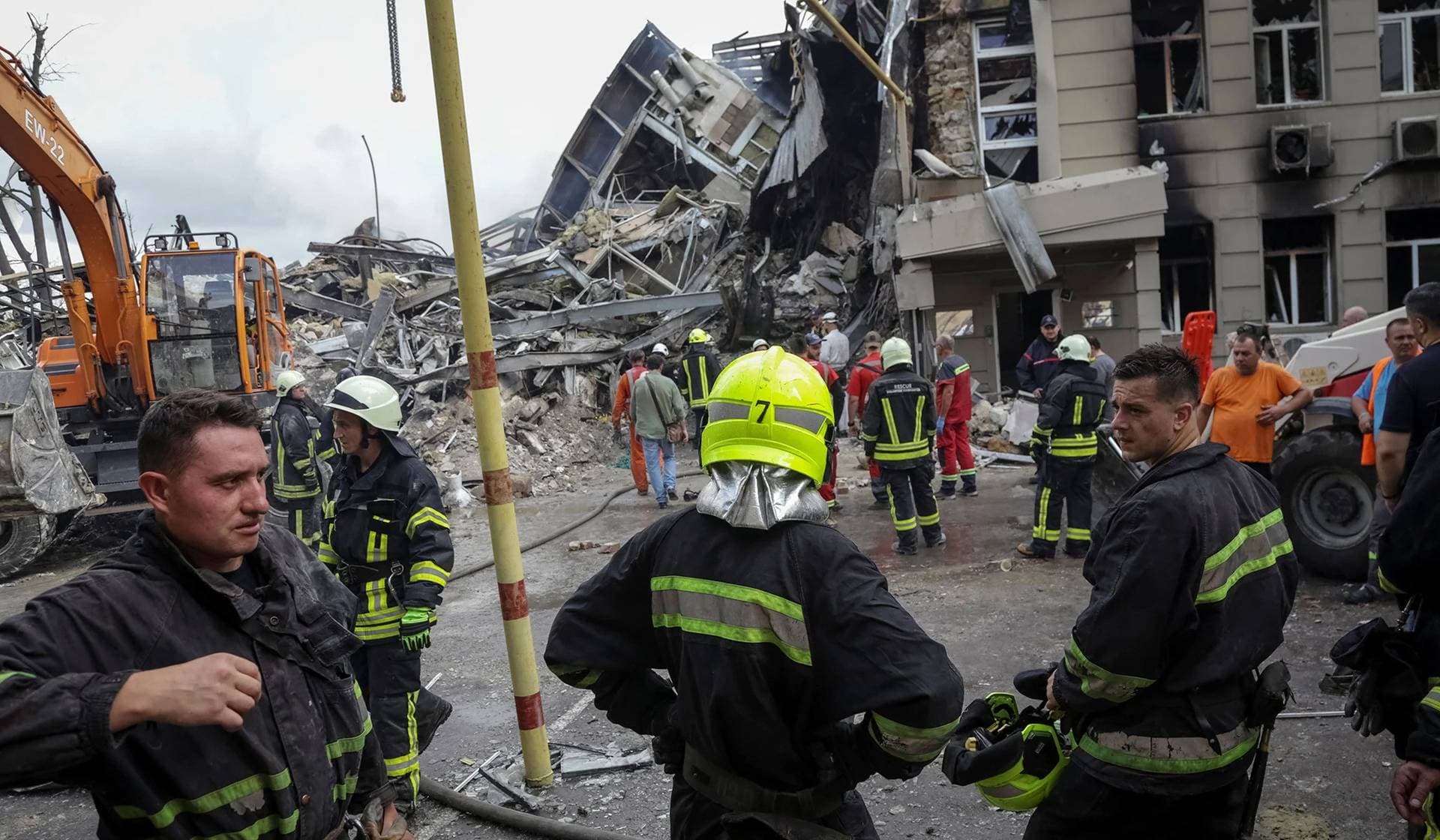 Rescuers work at a site of a building heavily damaged by a Russian missile attack in central Odesa