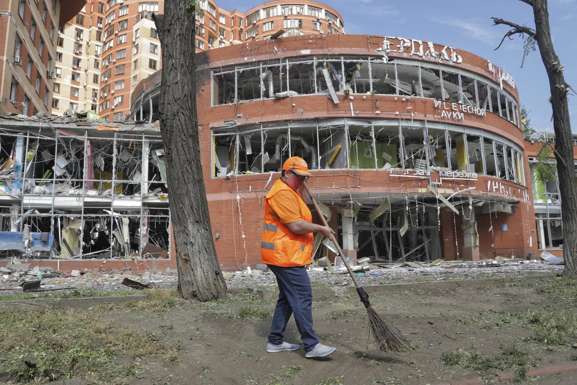 Municipal workers clean at the scene of a nightly Russian rocket attack in Odesa