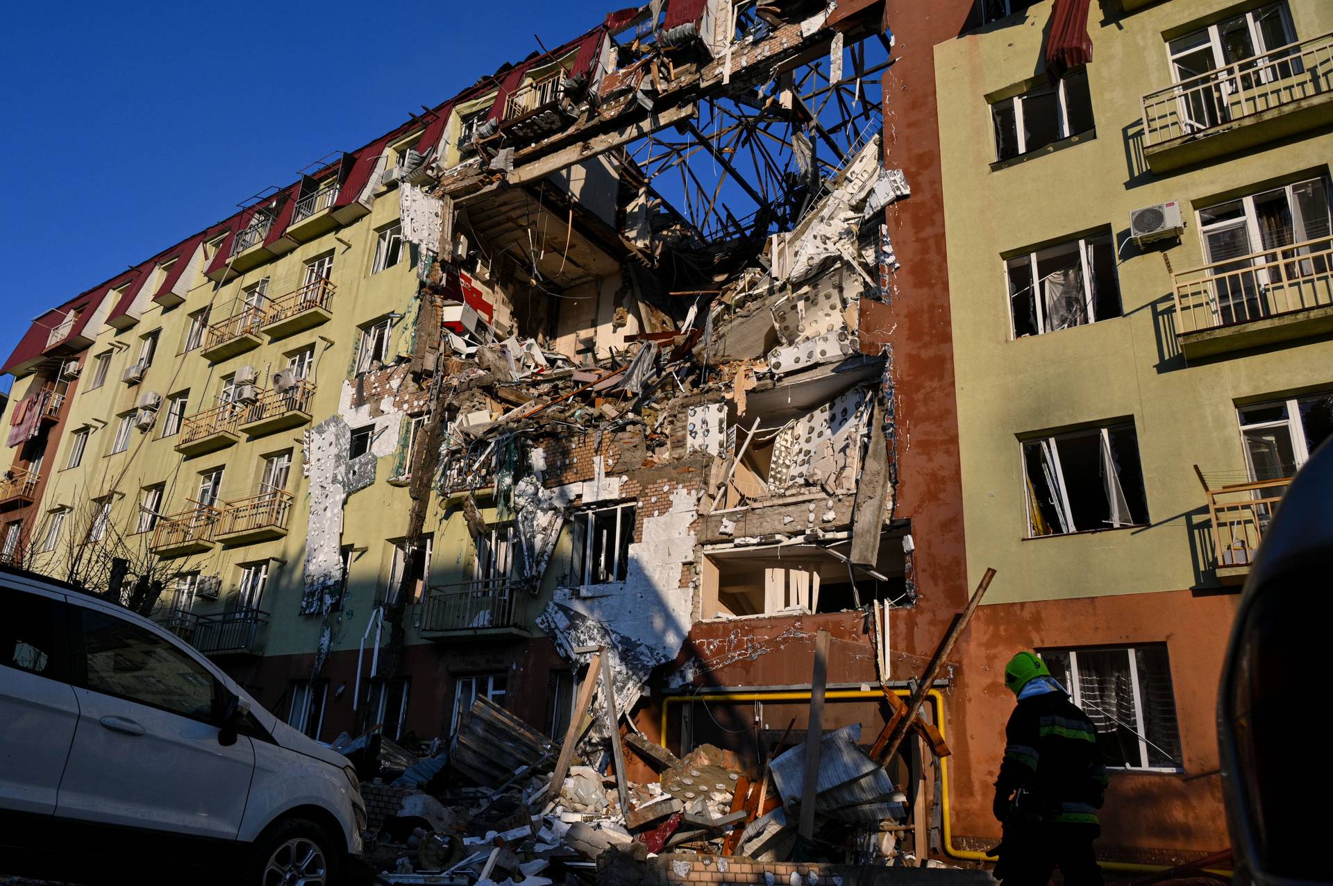 A rescue worker walks in front of residential building which was heavily damaged after a Russian strike in Odesa