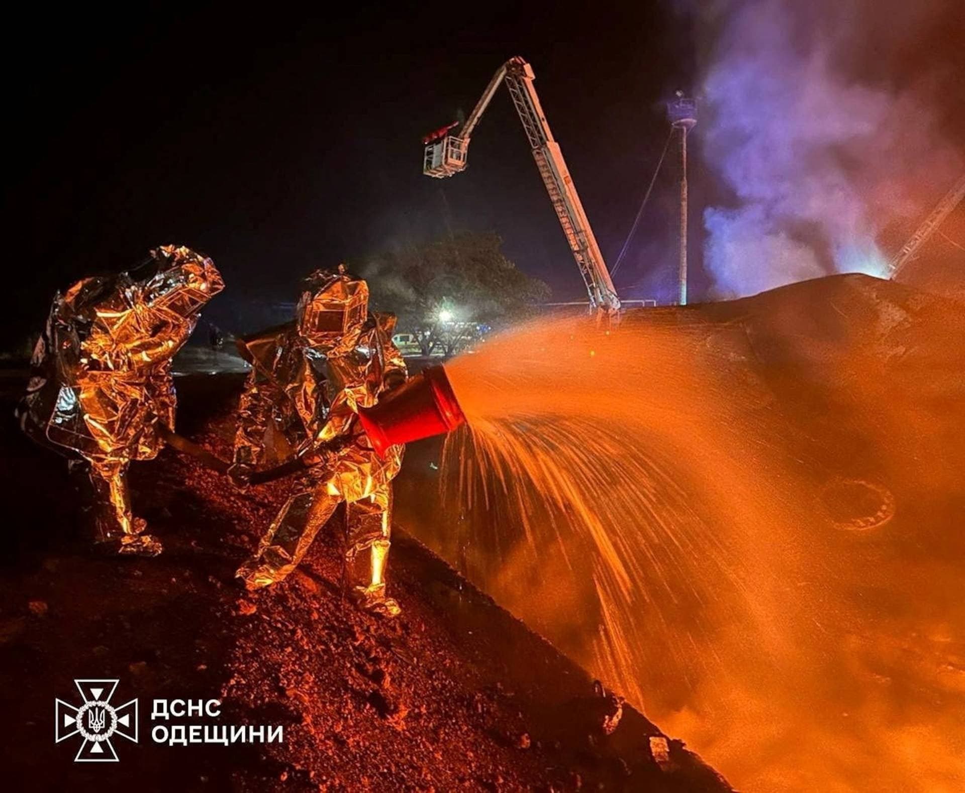 Firefighters work at the site of a fuel storage facility hit by a Russian drone strike in Odesa Region
