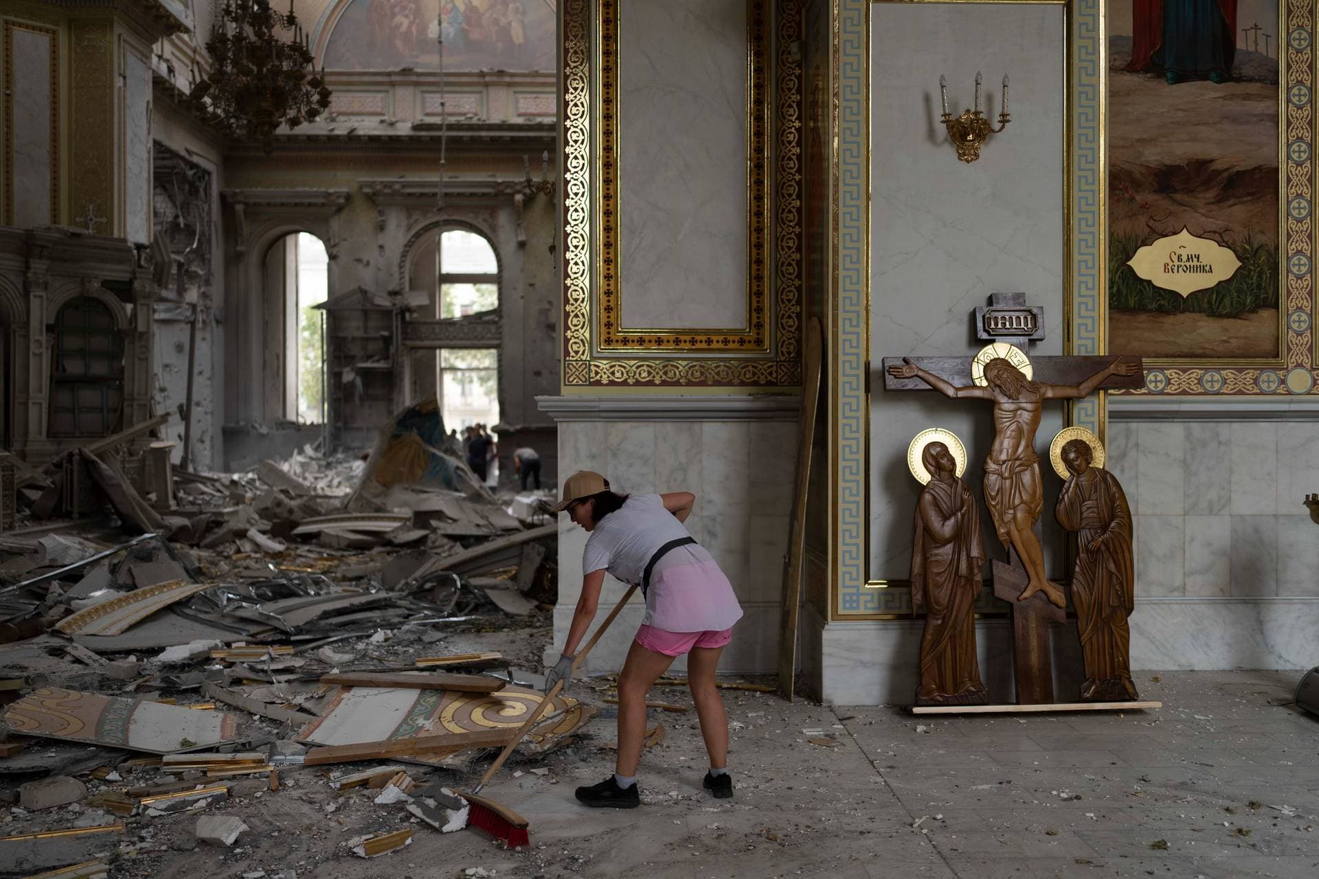 A woman helps clean up the Transfiguration Cathedral in Odesa