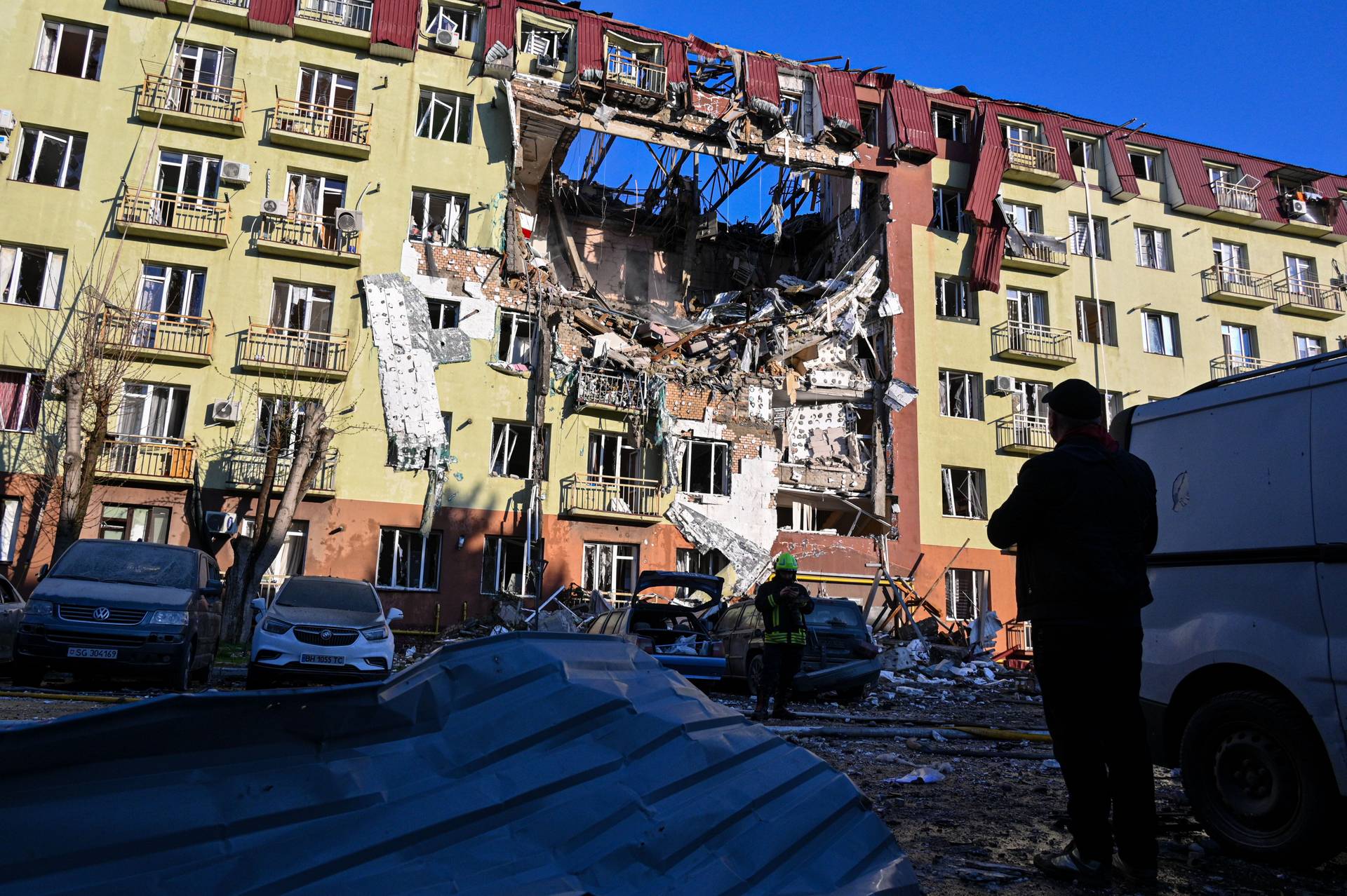 A rescue worker walks in front of residential building which was heavily damaged after a Russian strike in Odesa