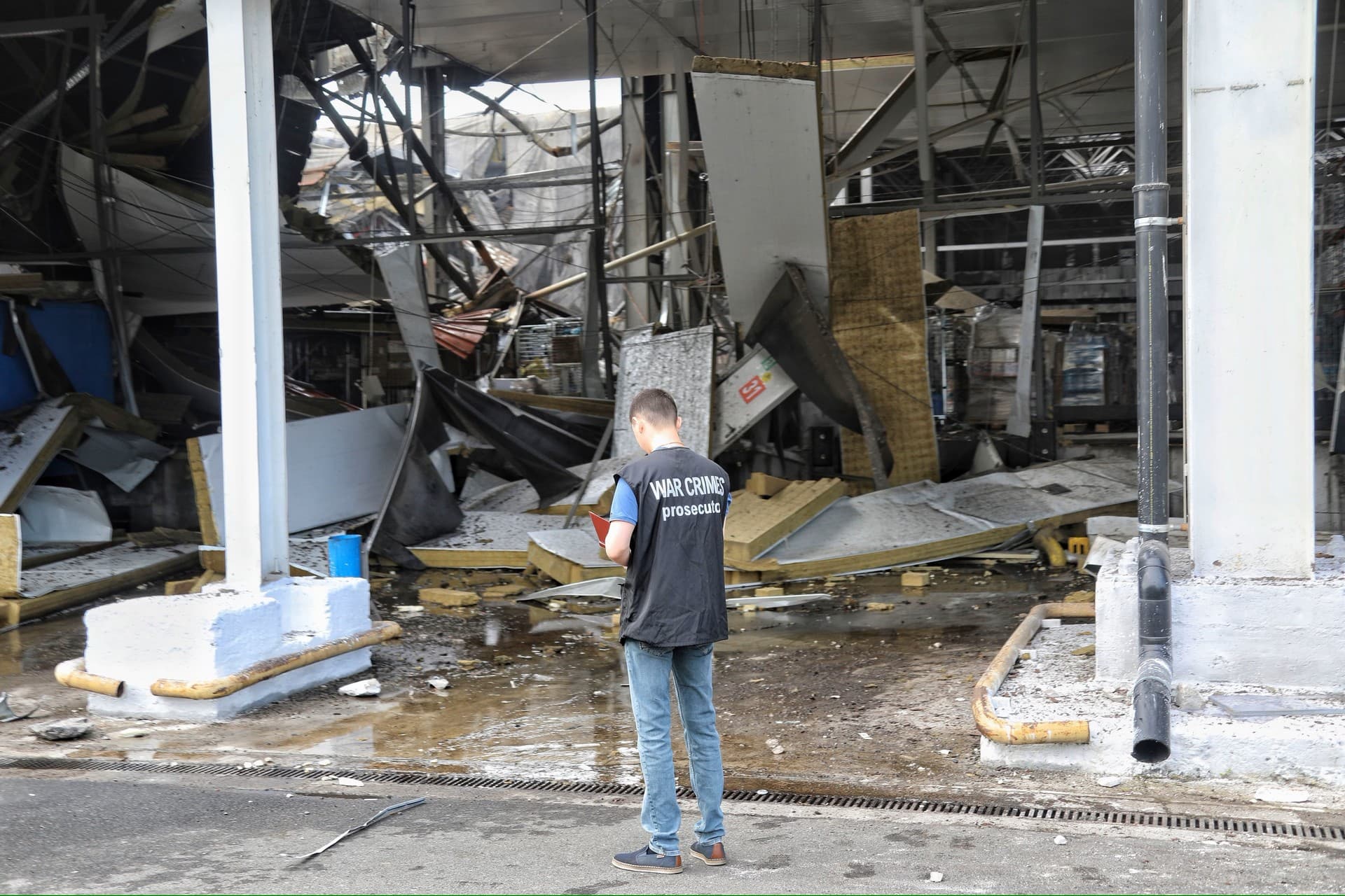A war crime prosecutor inspects a scene of a nightly Russian rocket attack in Odesa