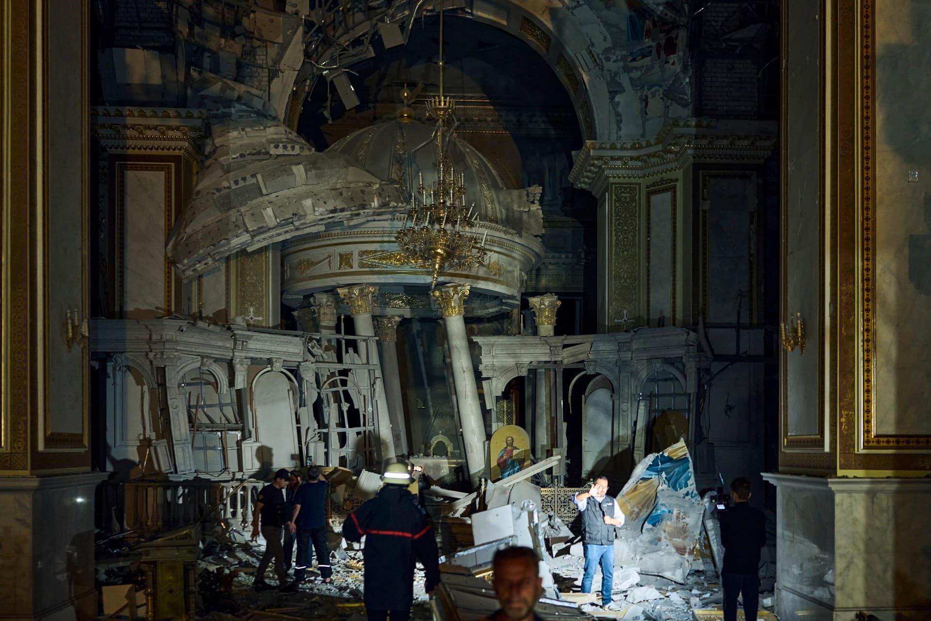 People walk inside the Odesa Transfiguration Cathedral, heavily damaged in a Russian missile attack in Odesa