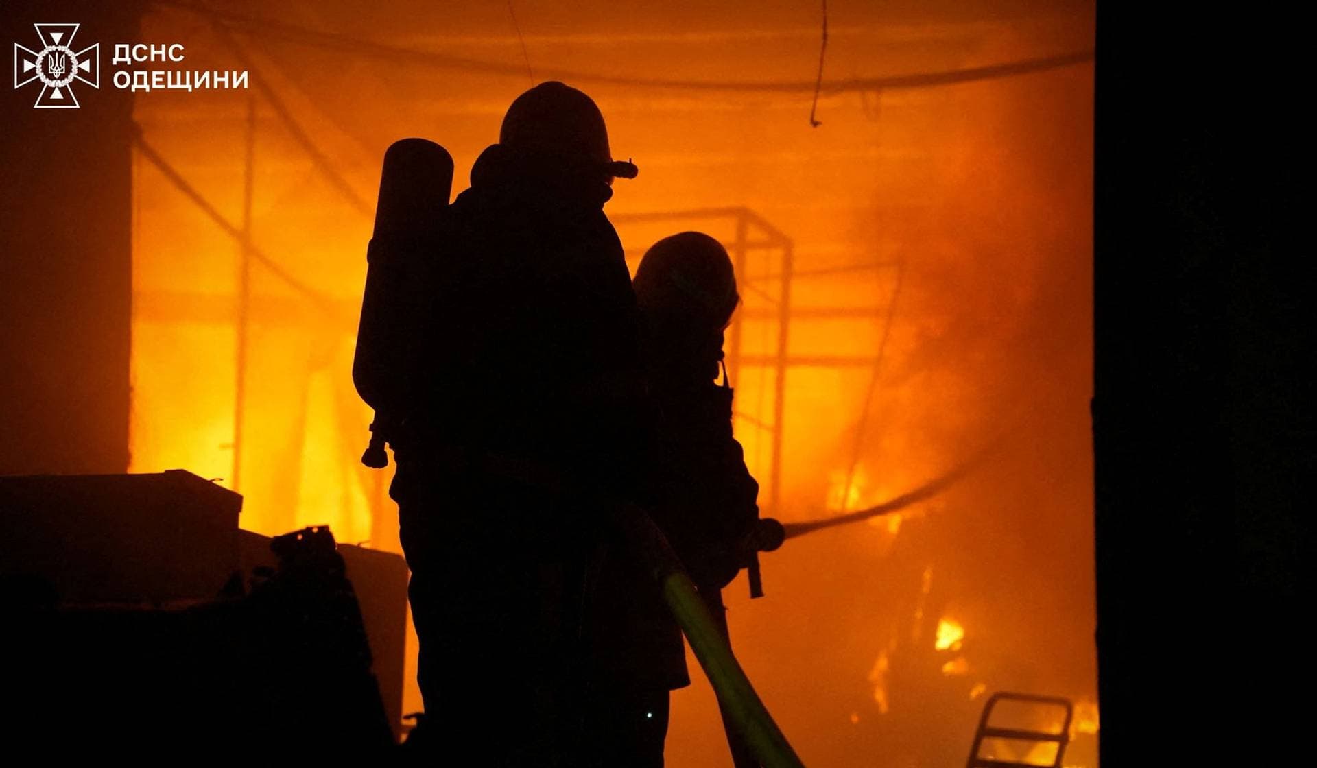 Firefighters work at a site of a Russian drone strike in Odesa