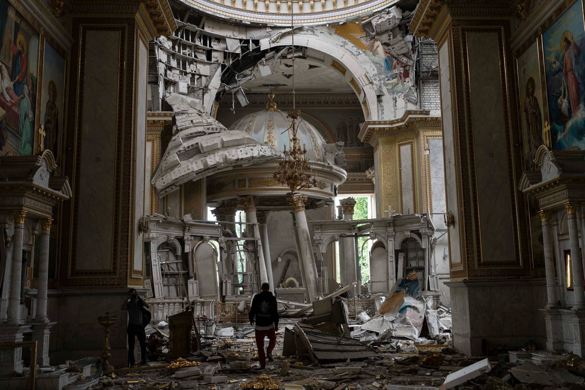 Church personnel inspect damages inside the Odesa Transfiguration Cathedral in Odesa