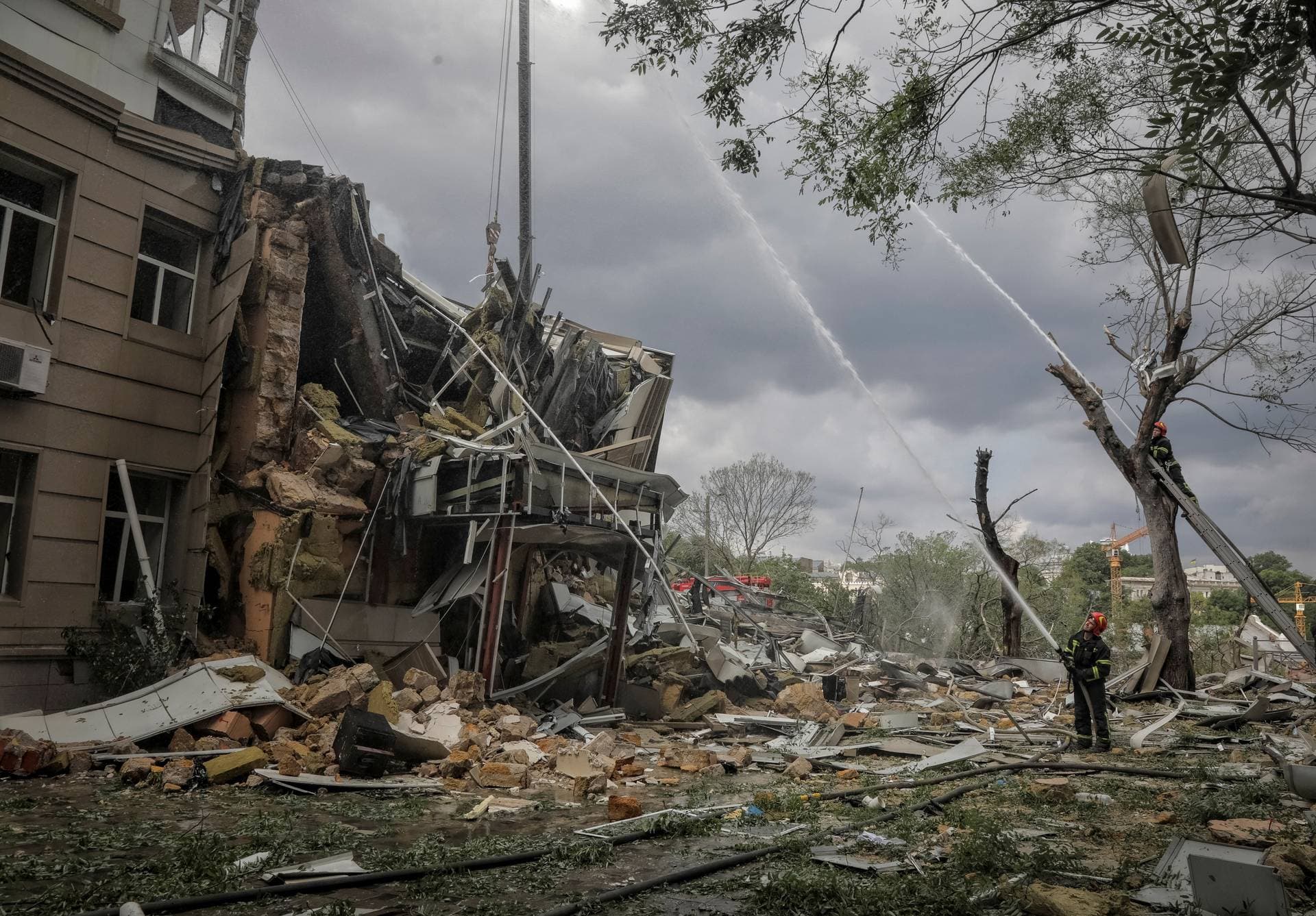 Rescuers work at the site of a building heavily damaged by a Russian missile attack in central Odesa