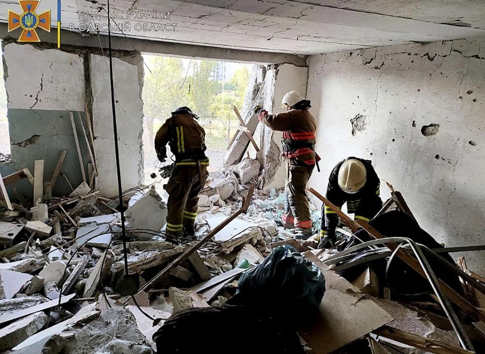 first responders work in a damaged residential building in Odesa