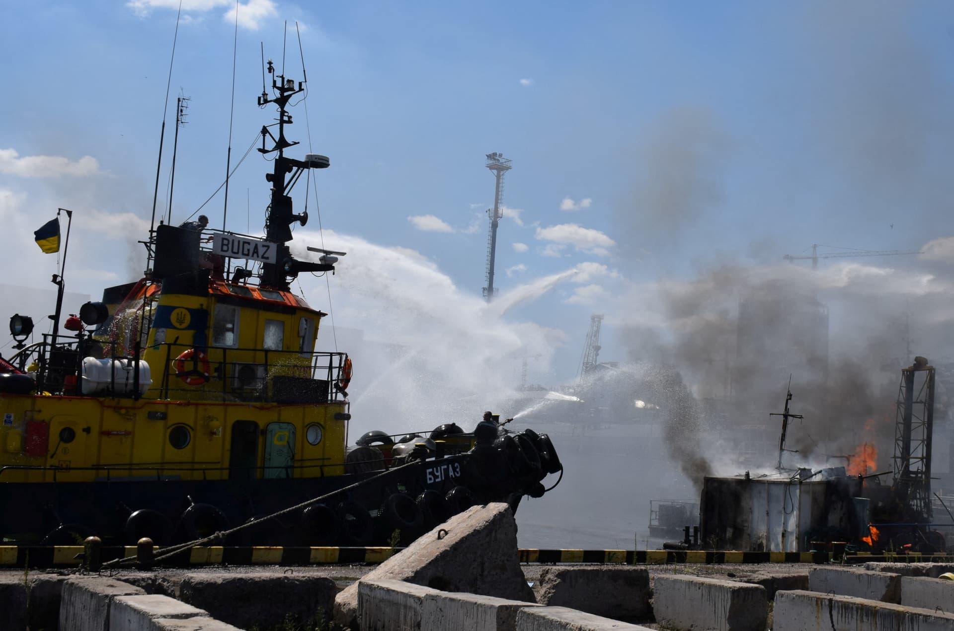 Firefighters work to put out a fire in a sea port of Odesa