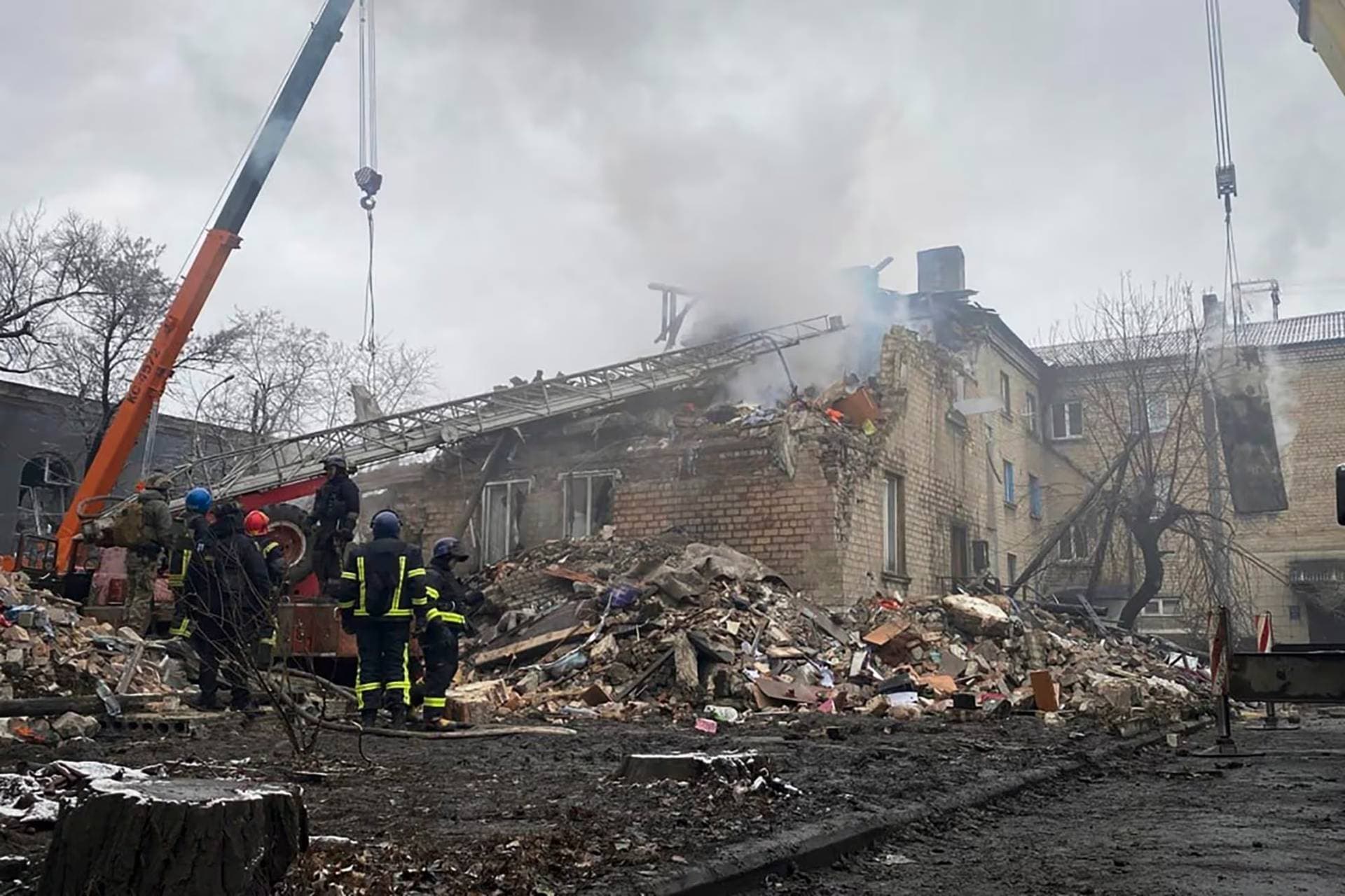 Rescuers work at the scene of a building damaged by shelling in Novogrodivka