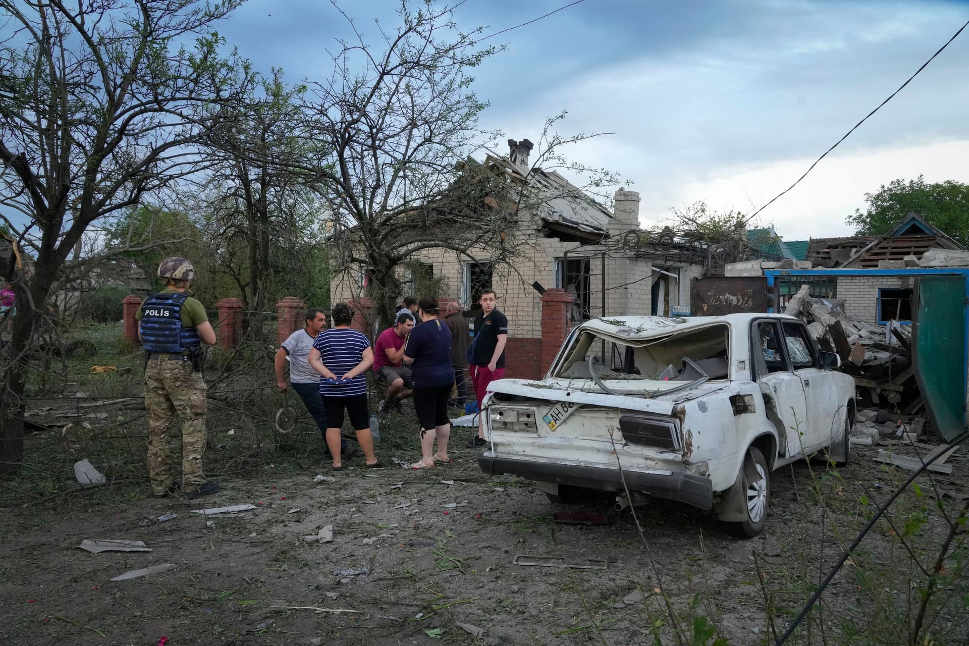 Residents gather near houses that were damaged by a Russian rocket attack in Pokrovsk