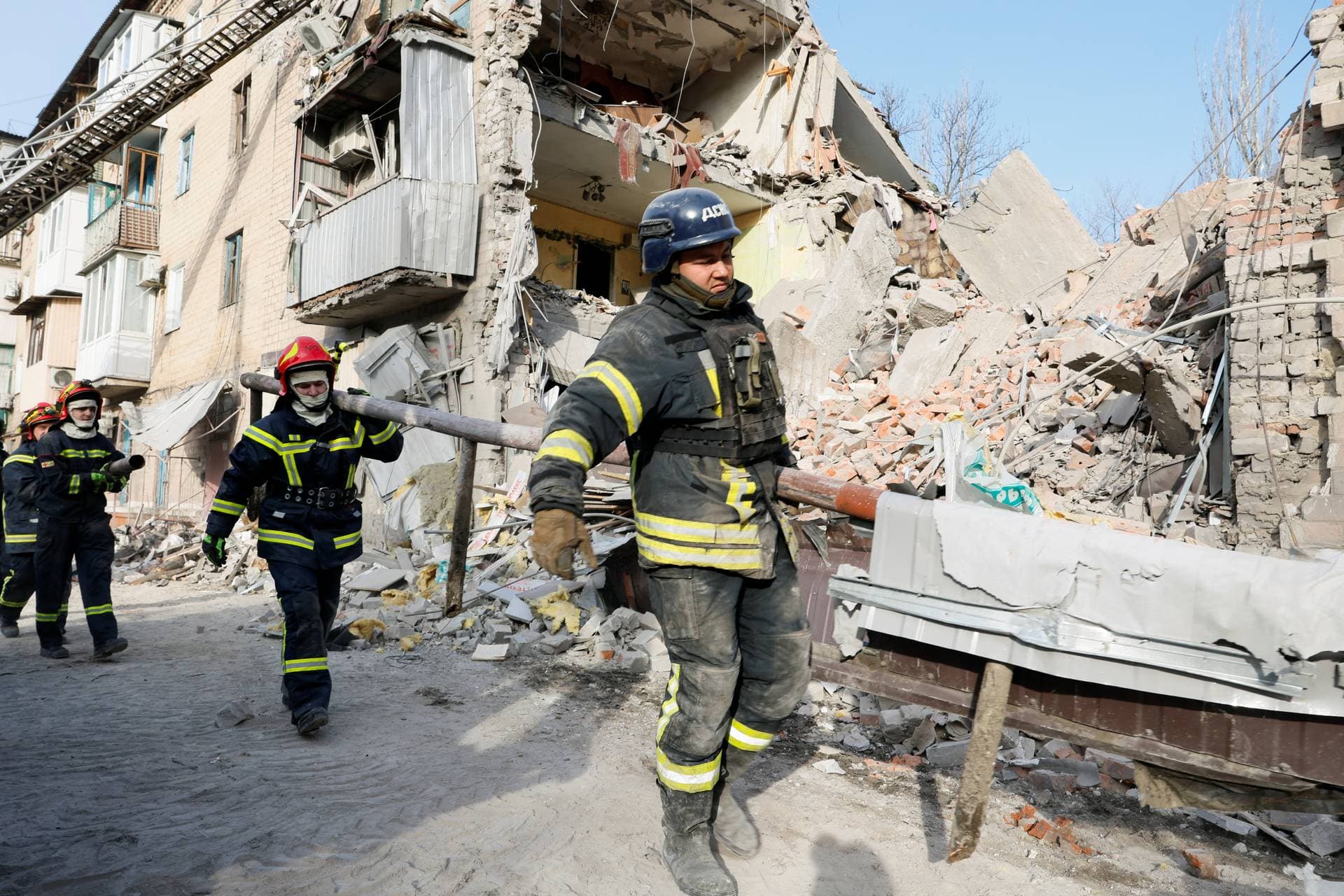 Rescuers work at the site of residential houses heavily damaged by a Russian missile strike in the town of Selydove