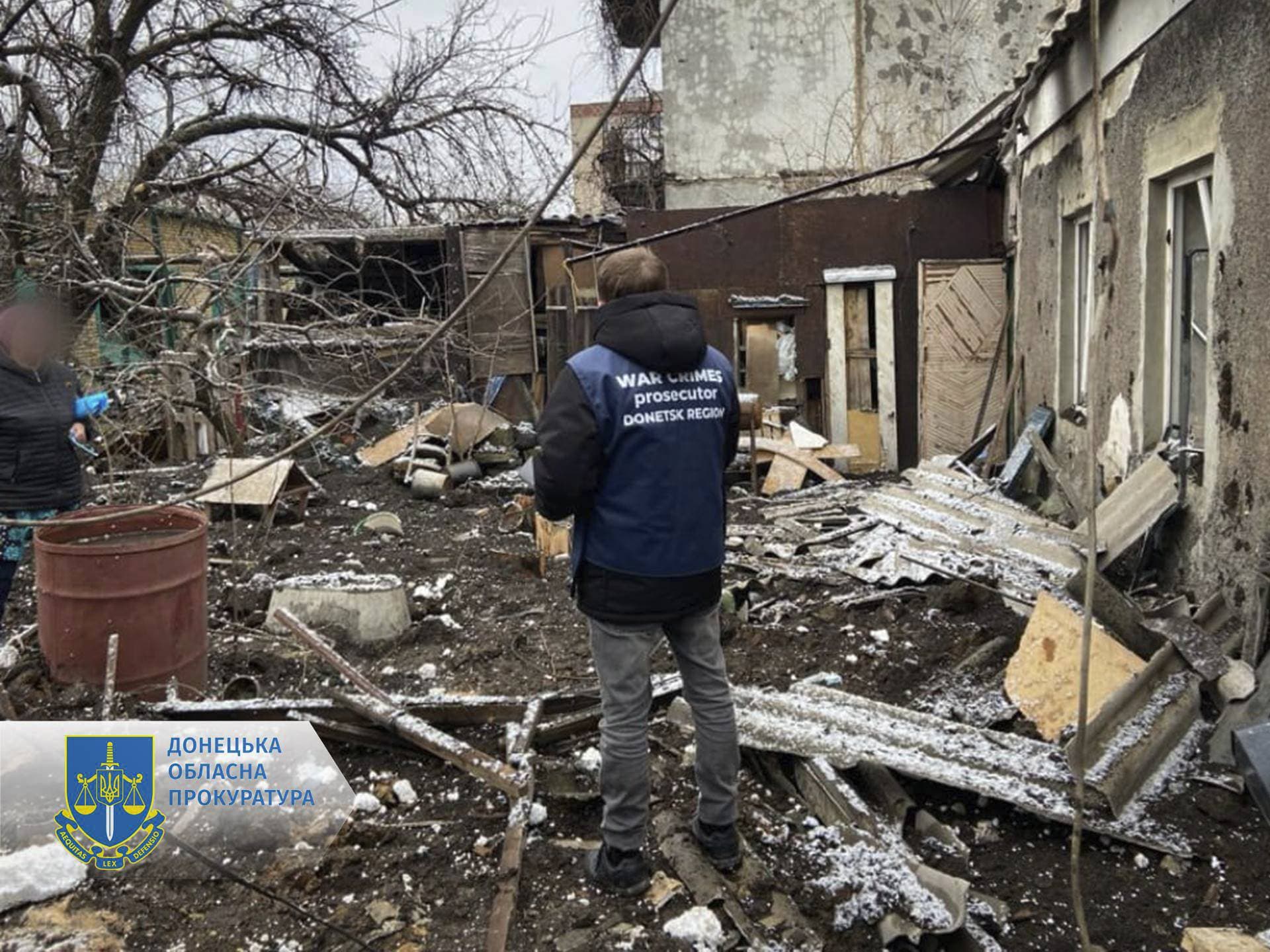 A war crime prosecutor inspects the scene after shelling in Pokrovsk