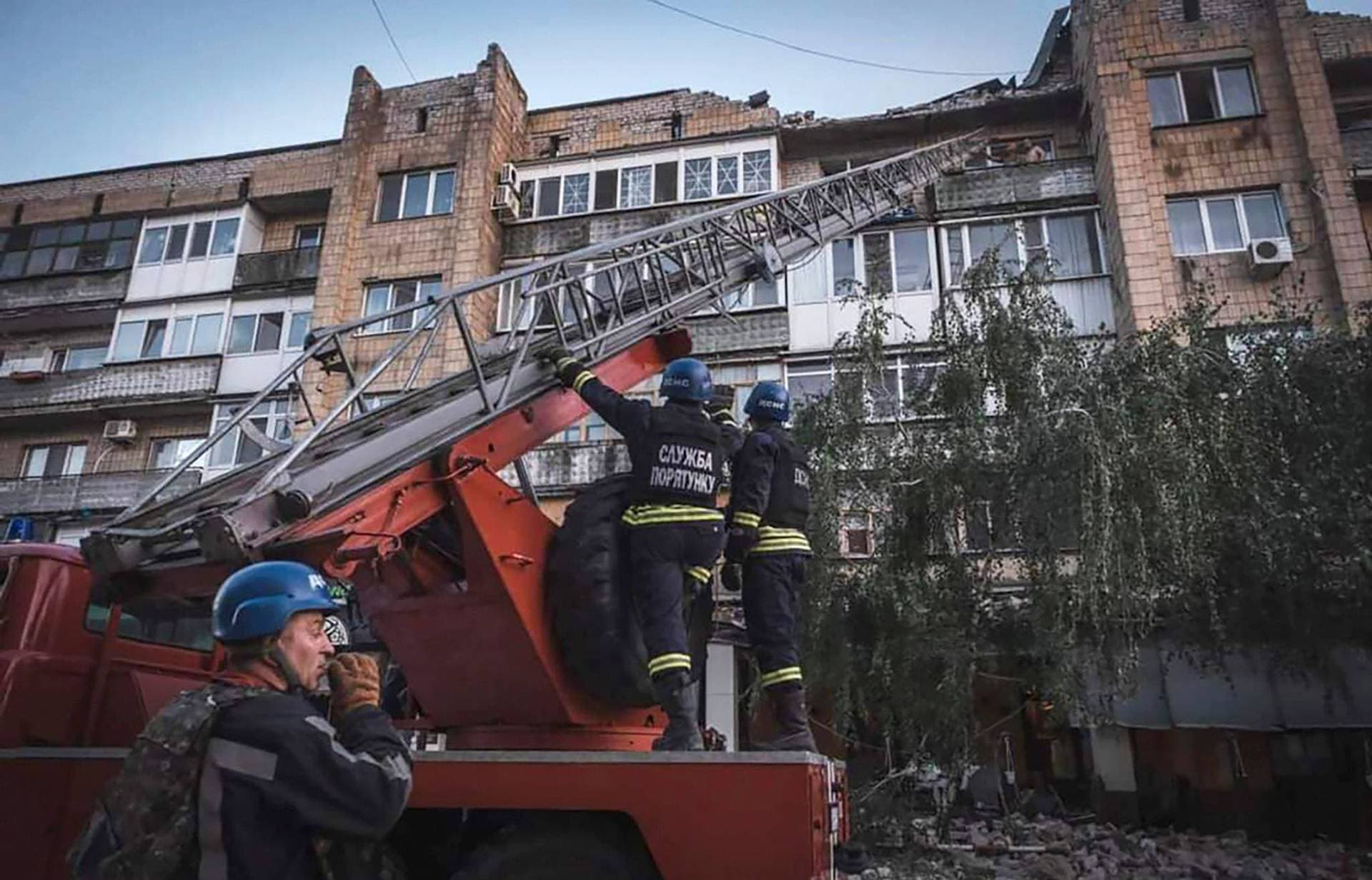 Rescuers work at the site where a building destroyed during a Russian missile strike in Pokrovsk
