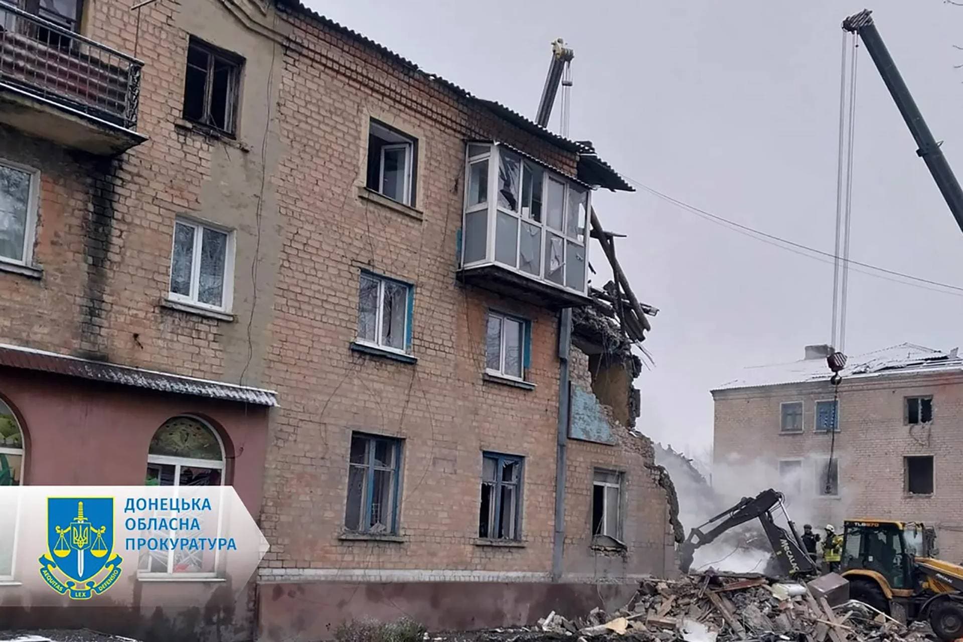 Rescuers work on the scene of a building damaged by shelling in Novogrodivka