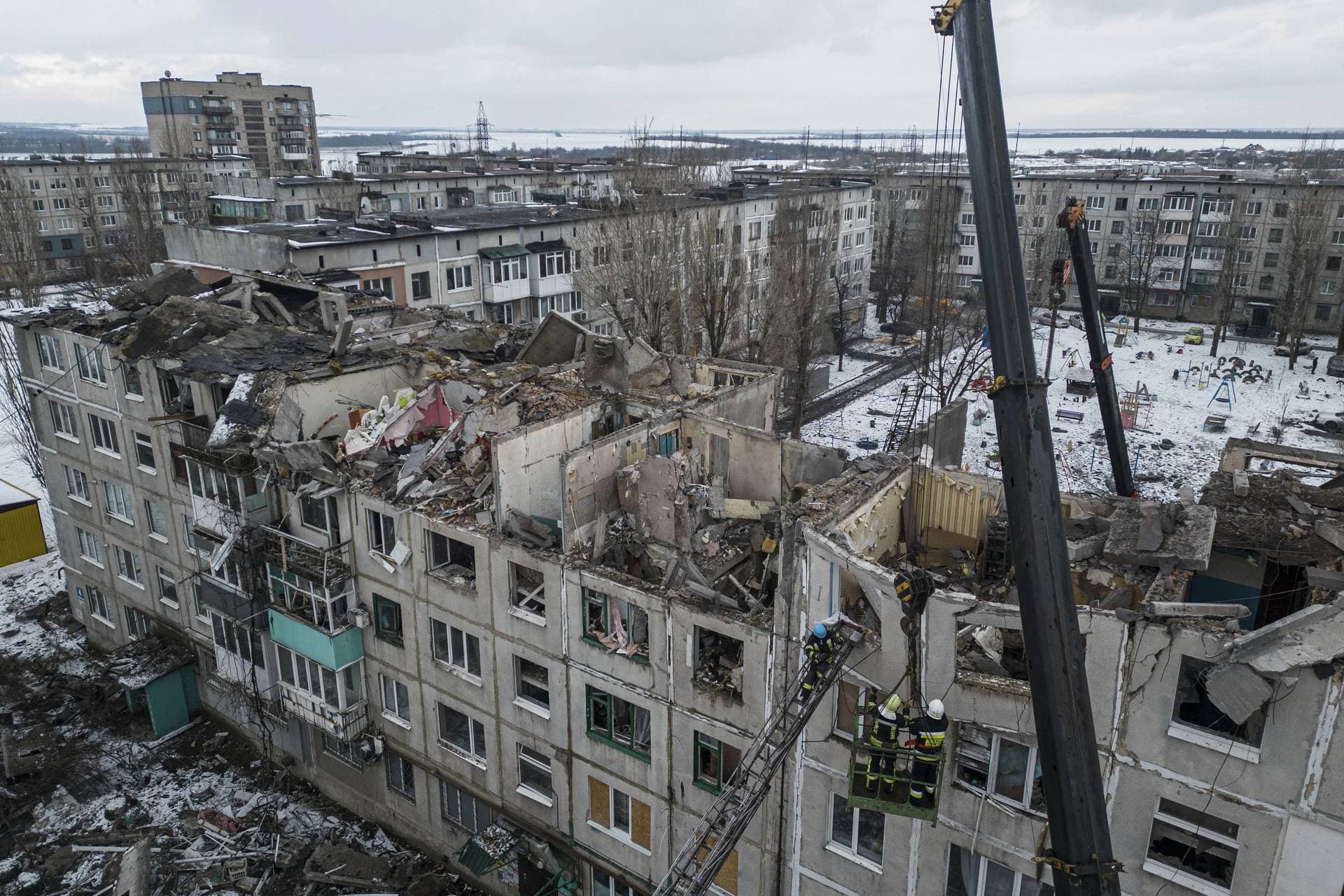 Rescue workers clear the rubble of the residential building which was destroyed by a Russian rocket in Pokrovsk