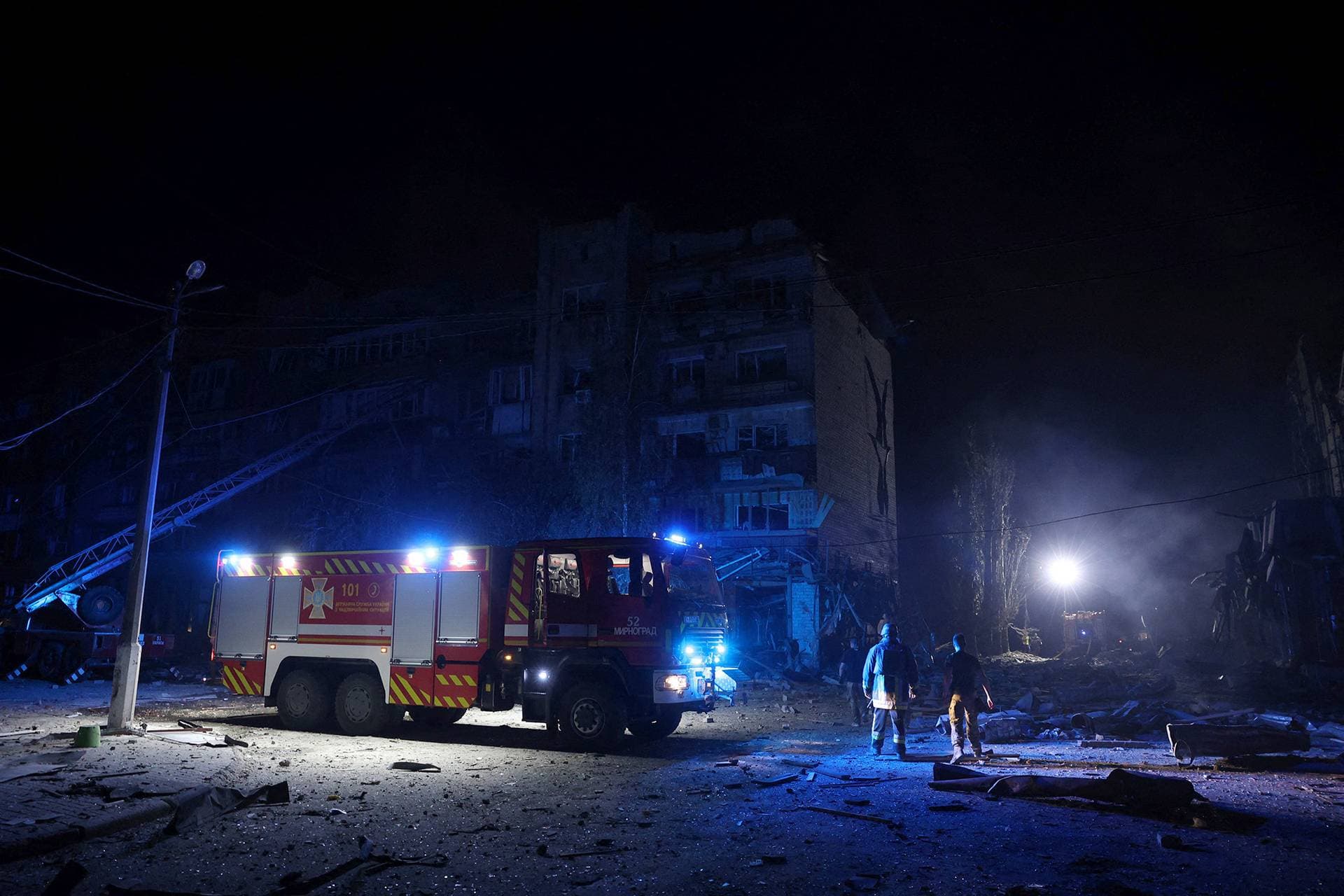 Rescuers are at work near a damaged residential building following Russian missiles strikes in Pokrovsk