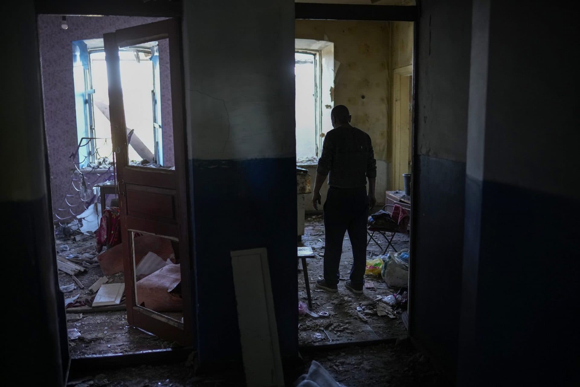 A local resident gathers up belongings from his heavily damaged house after a Russian strike in Pokrovsk
