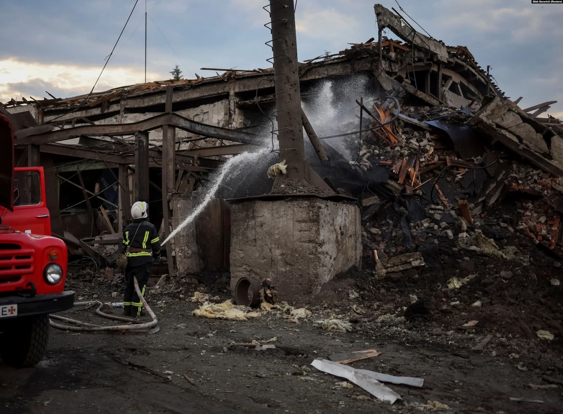 Ukrainian firefighters extinguish a fire caused by a Russian missile strike in the settlement of Dobropillya