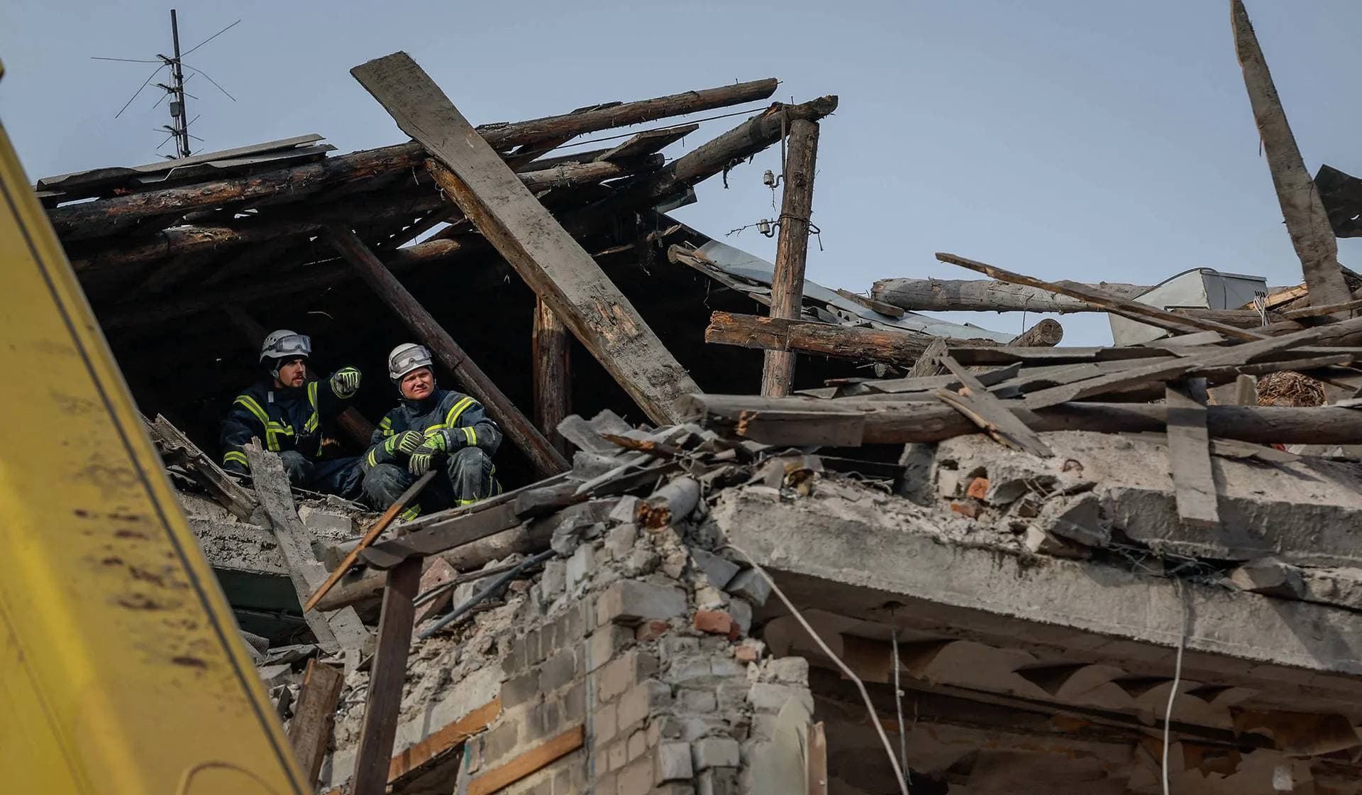 Rescuers work on a residential house heavily damaged by a Russian missile strike in Selydove