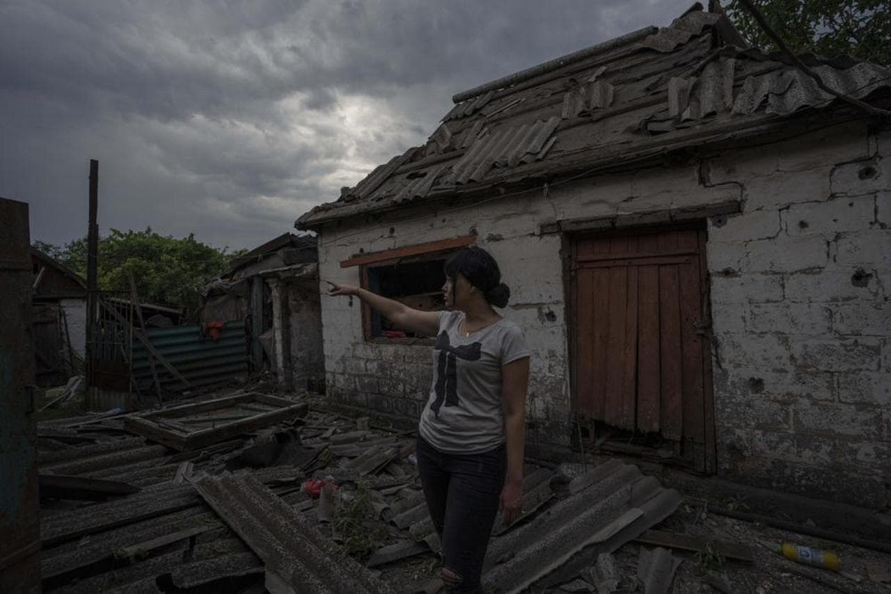 A resident stands in front of a damaged home, in the aftermath of a Russian rocket attack, on the outskirts of Pokrovsk