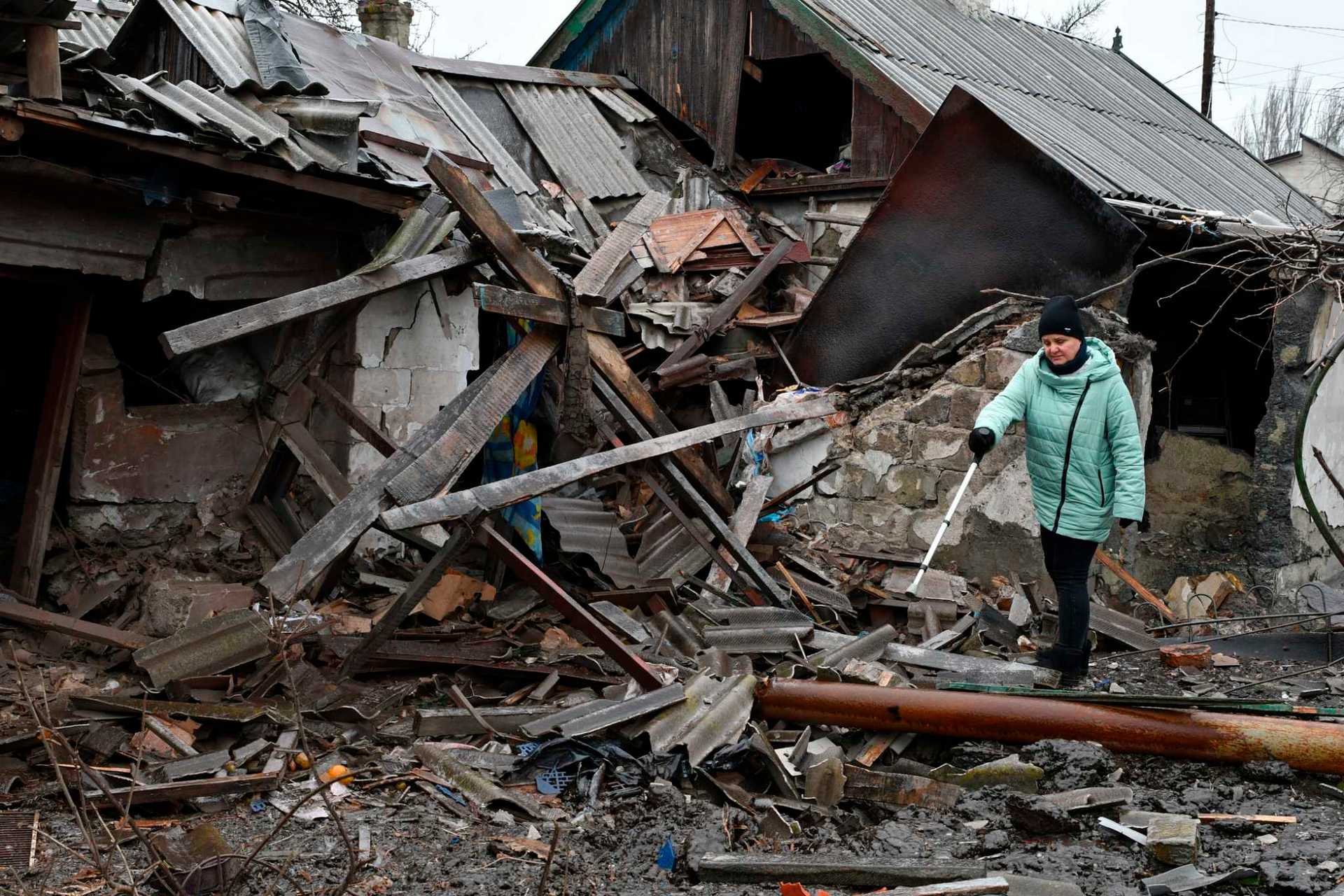 A woman stands near debris of her house following Wednesday's Russian shelling, in Kurakhove