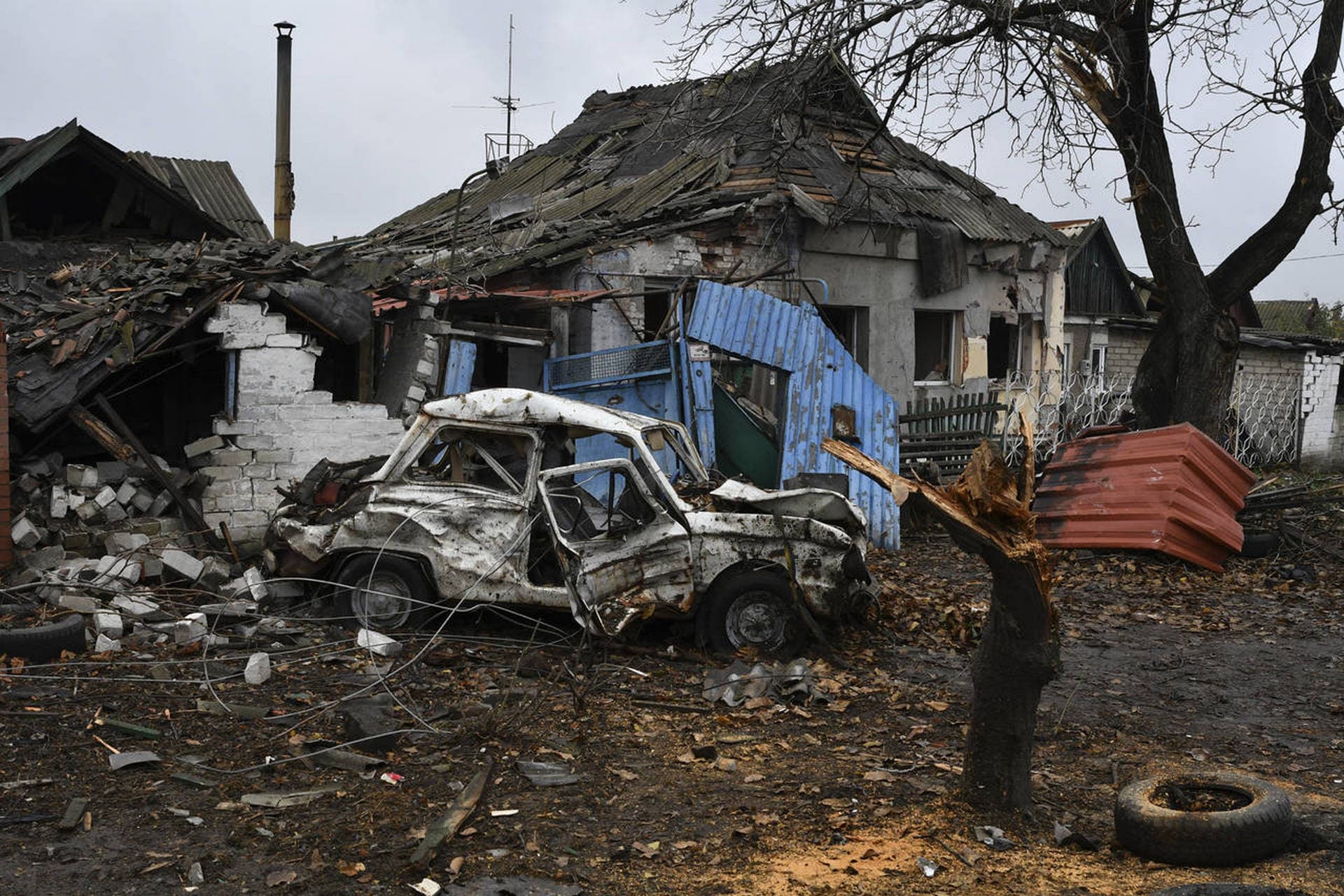 A damaged Soviet-era Ukrainian car Zaporozhets is seen next to a destroyed apartment building after Russian shelling in Pokrovsk