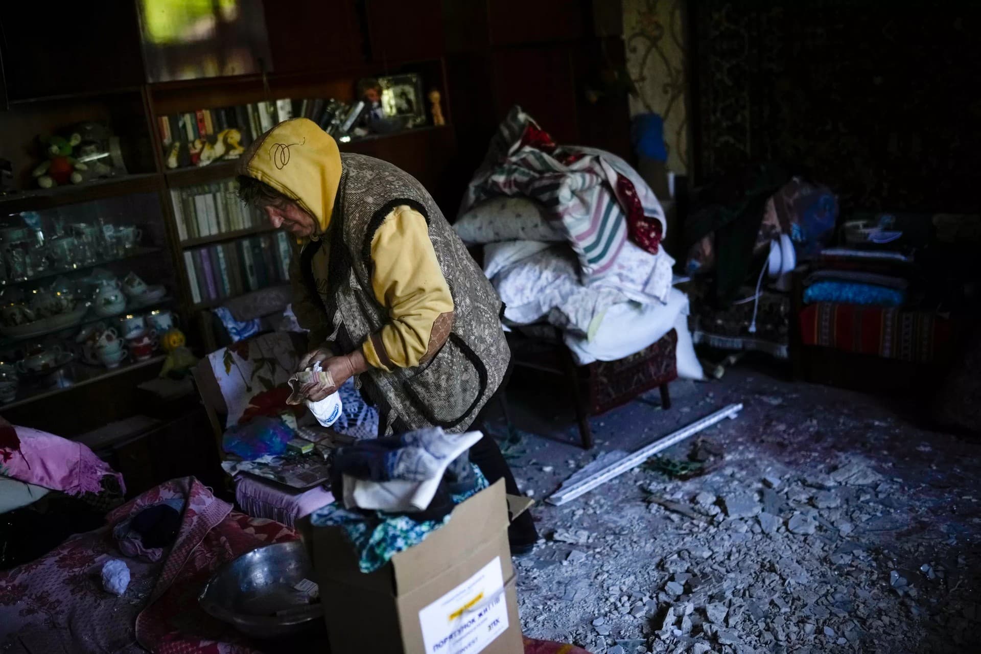 A local resident gathers up belongings from her heavily damaged house after a Russian strike in Pokrovsk
